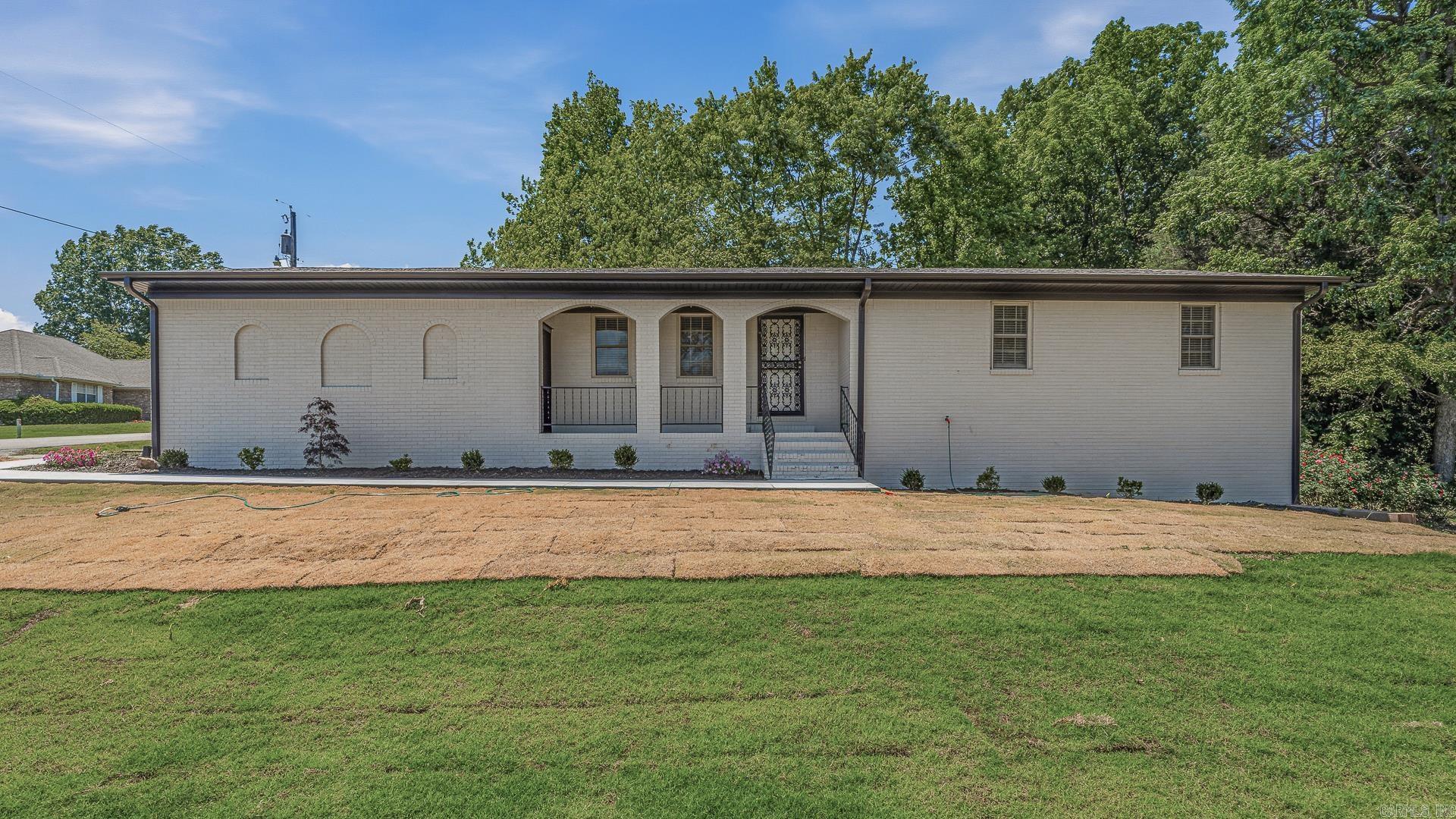 Spacious, stylish, and completely renovated, this all-brick home offers updated living space on nearly half an acre in the heart of town! Upstairs features 1,378 sq ft with 3 bedrooms and 2 fully remodeled baths, plus a bright living room that flows seamlessly into the kitchen and dining area. Recent updates throughout the home include fresh interior and exterior paint, all new flooring, updated hardware, and all new lighting, creating a clean and modern feel from top to bottom. Downstairs, the fully finished walk-out basement adds an additional 1,316 sq ft of versatile living space with a second living area, full bath, second laundry area, two bonus rooms ideal for guests, hobbies, or a home office, and a spacious storage room. Outside, enjoy all new landscaping, a newly added sidewalk, mature shade trees, and inviting outdoor spaces perfect for relaxing or entertaining. The oversized single-car garage adds even more functionality, while the convenient in-town location keeps shopping, dining, and everyday amenities close by.