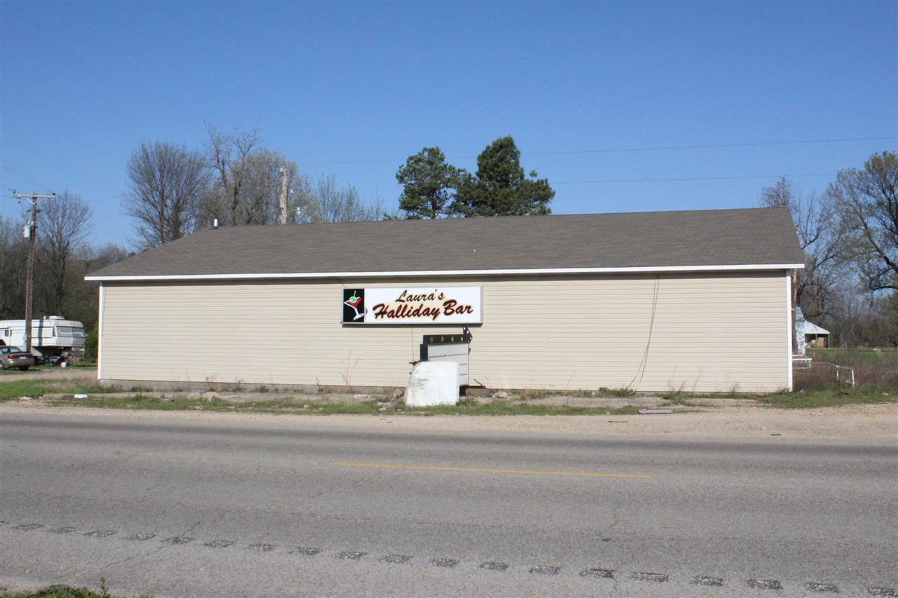 Great commercial space located on a busy highway. This property was previously a bar but it could be used for other businesses. With a little work it could easily be turned into a great restaurant. The inside features concrete floors, a large seating area, a bar with wood counter-top and a kitchen area. There is a large grave area outside with plenty of parking for customers. Don’t miss your chance on this great investment opportunity.