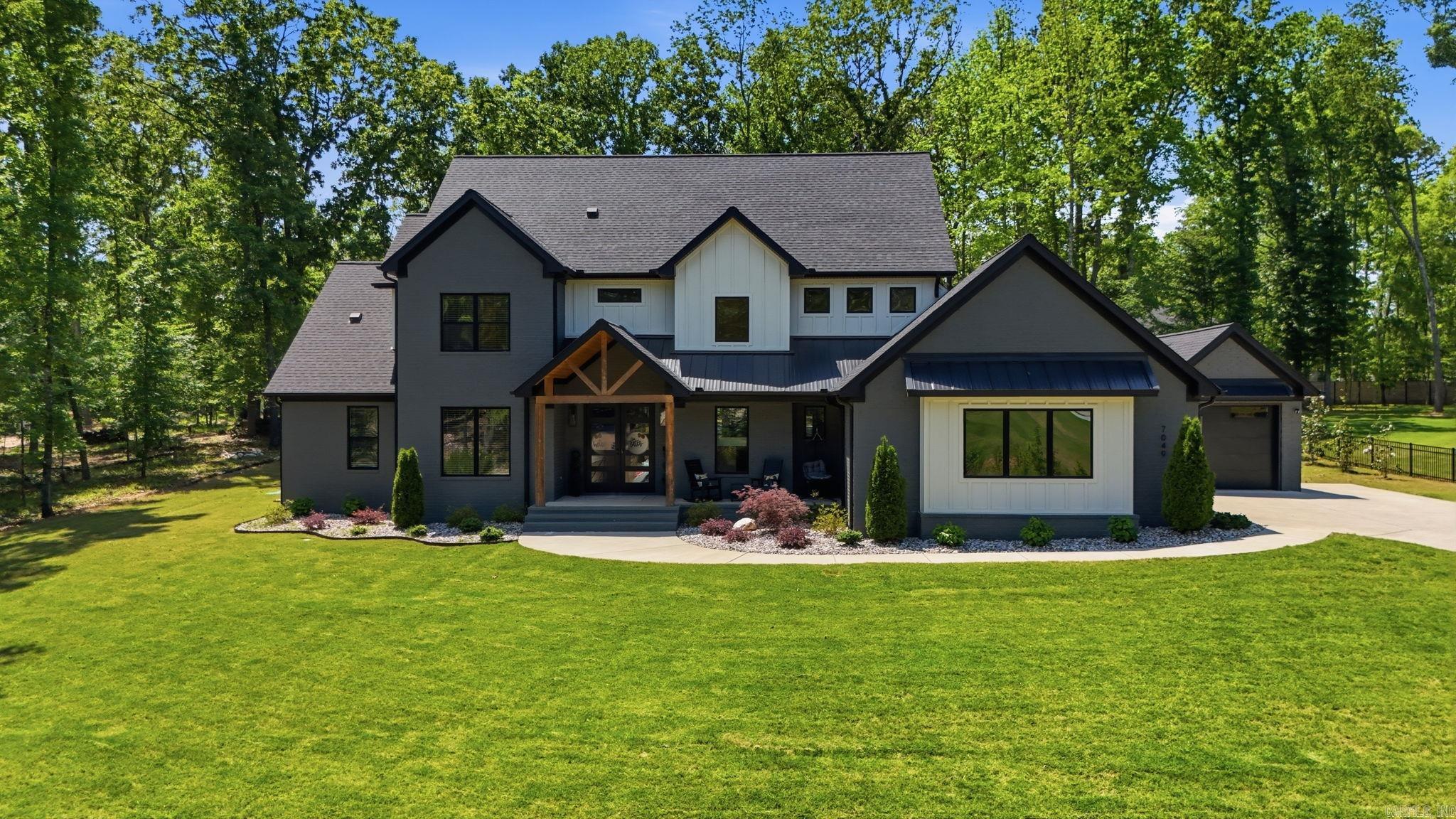 Welcome to this stunning 2023 traditional home in the Hazel Oak subdivision! Offering 3,612 sq ft of living space, 5 bedrooms, and 4.5 bathrooms on a private wooded lot. The main-level primary suite features modern finishes, a walk-in closet with stackable laundry, and a dreamy ensuite. Every closet in the home boasts custom built-in dressers - pure convenience. Upstairs, you'll find a full laundry room with a built-in desk featuring two workstations and storage cabinet - perfect for school or office. The open-concept kitchen features quartz countertops, large breakfast bar, and gas range, flowing seamlessly into a dramatic 2-story great room with a floor-to-ceiling fireplace. Enjoy a flexible sunroom and a dedicated office/study that can easily serve as a guest space with a full bath nearby. Outside, escape to your private oasis featuring an inground pool, covered patio, two-sided fireplace, and a gas grill hookup. Additional highlights include a 3-car detached side-entry garage, a unique breezeway, and energy-efficient windows. Conveniently located in Benton with easy access to local shopping, and dining. This like-new home is completely move-in ready—schedule your showing today!