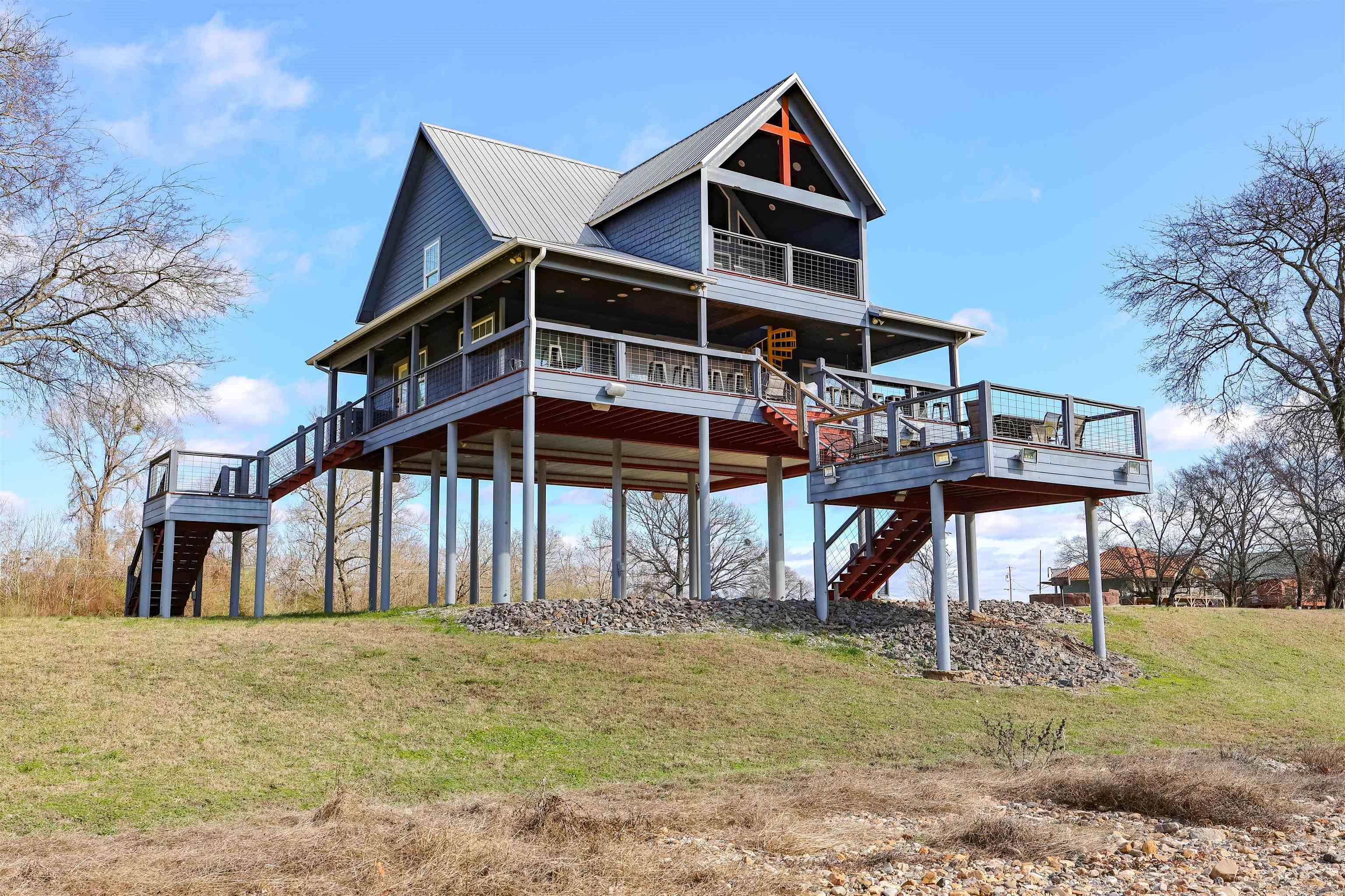Looking for a riverfront cabin on the Caddo River that sleeps 14 and already works as a vacation rental? Here it is! Caddo Lookout is a rustic, industrial style cabin that sits right on the Caddo River in the heart of Arkansas outdoor country and comes fully furnished and stocked, making it perfect as a short-term rental, weekend getaway, or full-time vacation home. Built for memories, this home features 2 queen bedrooms, 2 fun bunkrooms, and 2 full bathrooms, giving everyone space to relax after a day of floating the river, hiking nearby trails, or grilling on the decks that overlook the water. The open living area flows into a fully stocked kitchen with all appliances included, and every piece of furniture and décor conveys, so you can start earning rental income or enjoying your new river lifestyle right away. Wake up to peaceful water views, sip coffee on the deck, and fall asleep to the sound of the river. This is what cabin life on the Caddo feels like: calm, cozy, and connected to nature. With room to sleep up to 14 guests, this property is already set up for short-term vacation rentals and large family stays, making it a smart investment and a dream retreat all in one.