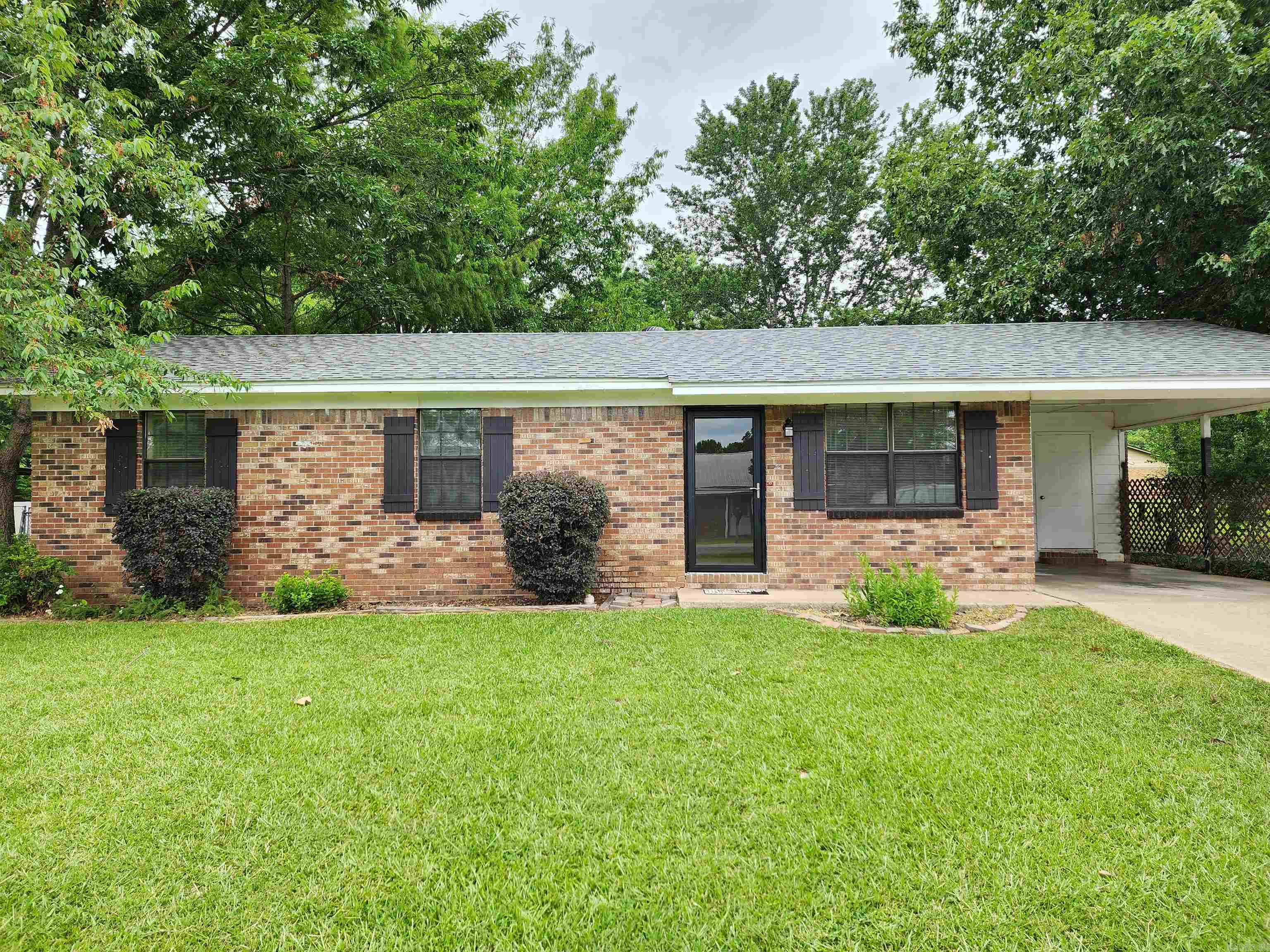 Take a look at this very well maintained home that boasts updated kitchen and bathroom with new paint throughout home. 3 bedroom, 1 bath and large laundry room along with a huge 18x20 heated and cooled bonus room off of the kitchen.  Beautiful large flat shaded back yard that is fenced and has a large storage building that is wired for electricity with lots of shelving for storage.  Utility room off of the carport can be used for more storage along with chest freezer that conveys with the home.  Square Footage is approx, please measure.  AGENTS SEE REMARks