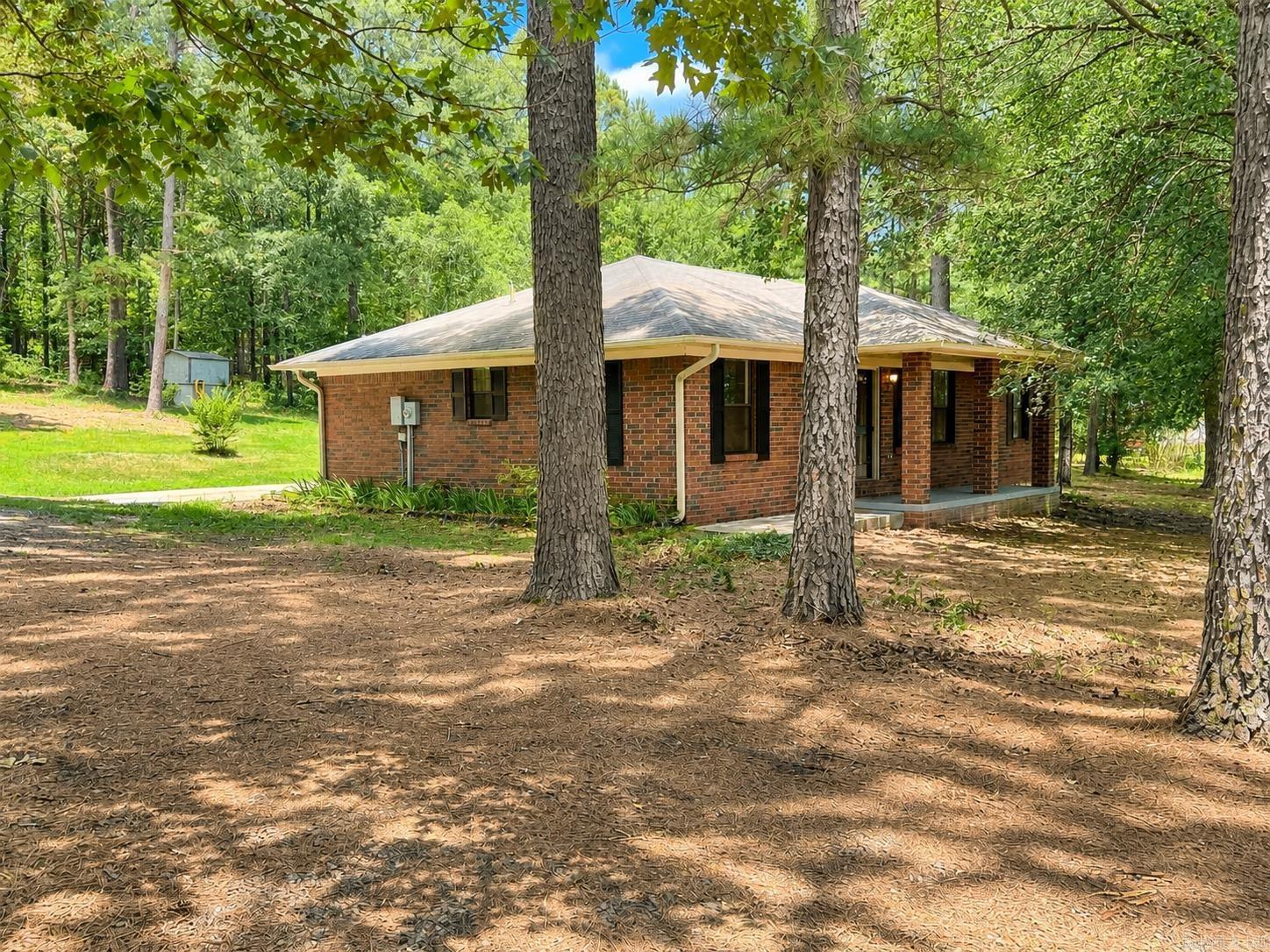 Move-in ready country gem on 1.5 ACRES! Located just 6 miles west of Perryville, this completely remodeled brick RANCH HOME offers the perfect blend of modern updates and tranquil privacy. Step inside to find brand-new LVP flooring throughout and a spacious, efficient GALLEY KITCHEN fully equipped with new cabinets, appliances, and beautiful butcher block countertops. Both FULL BATHROOMS have been stunningly upgraded with top-notch tiled surround showers, one including a deep soaking tub. Enjoy the ultimate peace of mind knowing the owner has already completed all major inspections —including roof, HVAC, and the septic system. The property features PRIVATE, quiet neighbors and abuts a timber company to the north, creating a true WILDLIFE haven surrounded by mature pines and hardwoods. Bonus: The attached rear carport is primed to be transformed into your dream OUTDOOR ENTERTAINMENT oasis or a custom four-season room. Plenty of space for a POOL and GARDEN SPACE with an existing well along with the public water. This one is truly a must-see!   ** Some images are digitally staged  **