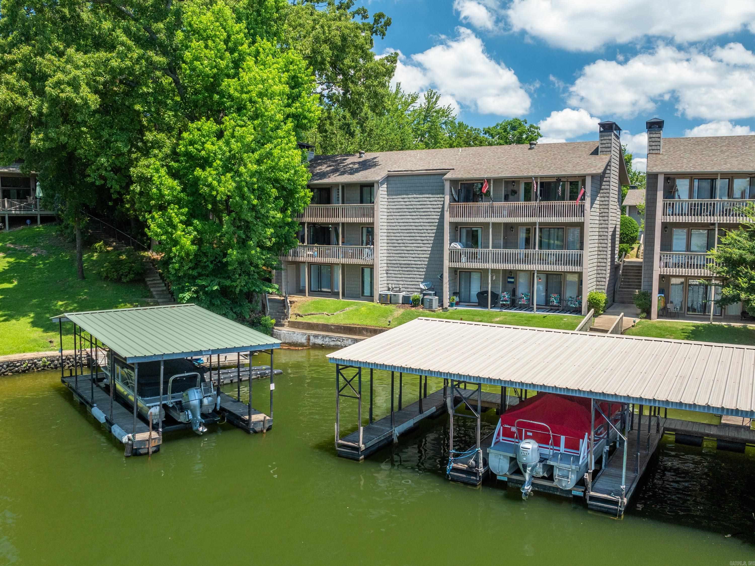 Welcome to The Moorings on Lake Hamilton, where prime location meets stunning main channel views. This beautifully updated 2-bedroom, 2-bath condo offers the perfect blend of comfort, convenience, and true lakefront living in one of Hot Springs’ most desirable areas. Enjoy wide-open views of the main channel from your private balcony—perfect for morning coffee, evening sunsets, and watching boats pass by. Even better, your dedicated covered boat slip is visible from the balcony and just steps away, making lake days effortless and convenient. Inside, the home features fresh paint, updated LED lighting, and a bright, modern feel throughout. The kitchen is designed for both everyday living and entertaining, with quartz countertops, stainless steel appliances, and ample cabinet space. Both bathrooms have been tastefully remodeled with quality finishes, offering a spa-like retreat. Located in the gated Moorings community, you’ll enjoy amenities including a private swimming pool and tennis court, all while being just minutes from Hot Springs’ top restaurants, shopping, and marinas. Whether you’re looking for a weekend escape or full-time lake home, this move-in ready condo with unbeatabl