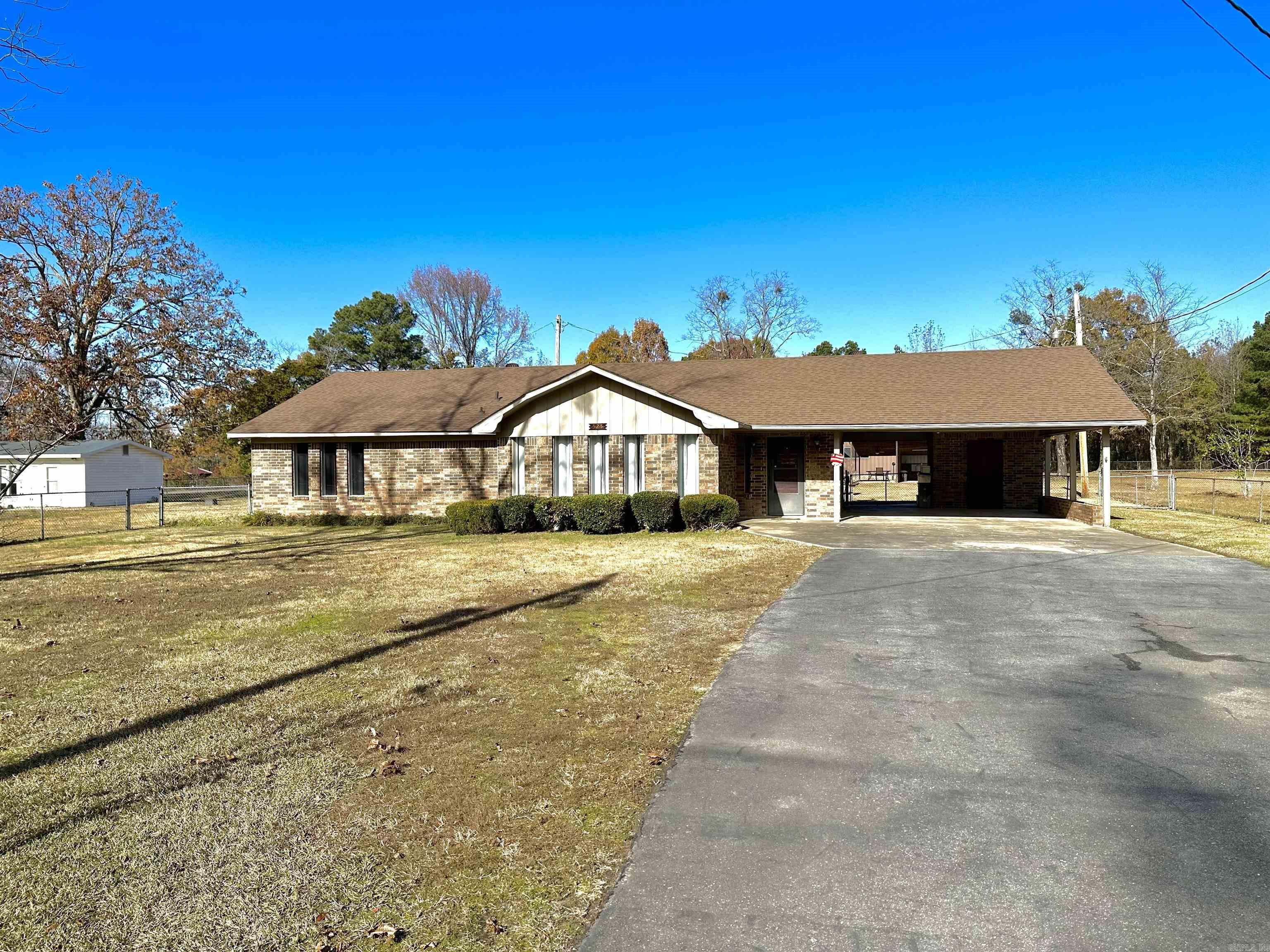 Located in the White Hall School District, this property offers the perfect combination of quiet, country living and convenient access to the city. Just 20 minutes south of Little Rock, you can enjoy the charm of small-town life while being near the interstate for easy travel. Set on over 2 acres, the property features a large shop with two bay doors, ideal for a variety of uses, as well as an additional storage shed. An outbuilding with full utilities, previously used as a salon, offers fantastic potential for a home business or creative space. The entire property is fully fenced with two points of entry through double gates, providing both security and privacy. Inside the home, you'll be welcomed by a huge living room with floor-to-ceiling windows, filling the space with natural light. The formal dining room and breakfast nook provide ample room for family gatherings. The master suite offers a private retreat, while the separate laundry/utility room adds convenience. An attached two-car carport completes this inviting home, making it an ideal choice for anyone seeking peaceful country living with plenty of space and potential.