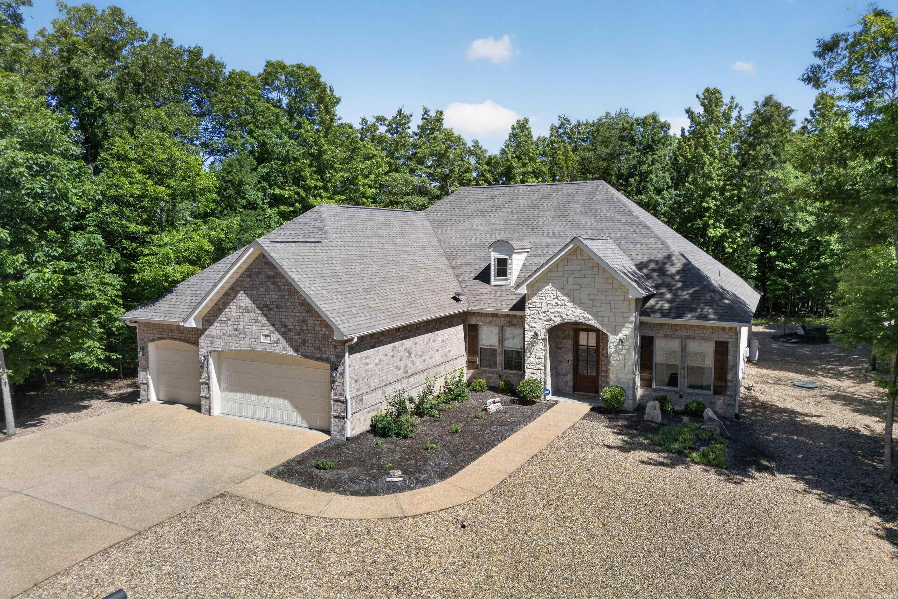 Meticulously cared for newer construction in Hot Springs Village on an almost half acre lot. This home features an open concept layout with beautiful wood floors, a spacious great room filled with natural light, and quality finishes throughout. The kitchen offers granite countertops, double ovens, a large pantry, and plenty of cabinet space, making it perfect for both everyday living and entertaining. Relax in the spacious primary suite with a stunning Roman tiled shower. Deep 3 car garage provides excellent storage, workspace, and room for larger vehicles or recreational equipment. Screened in back porch. 65" tv in den to convey. Situated on a large peaceful lot in the gated community of Hot Springs Village with access to golf, lakes, trails, fitness centers, and more. Move-in ready with thoughtful details throughout!