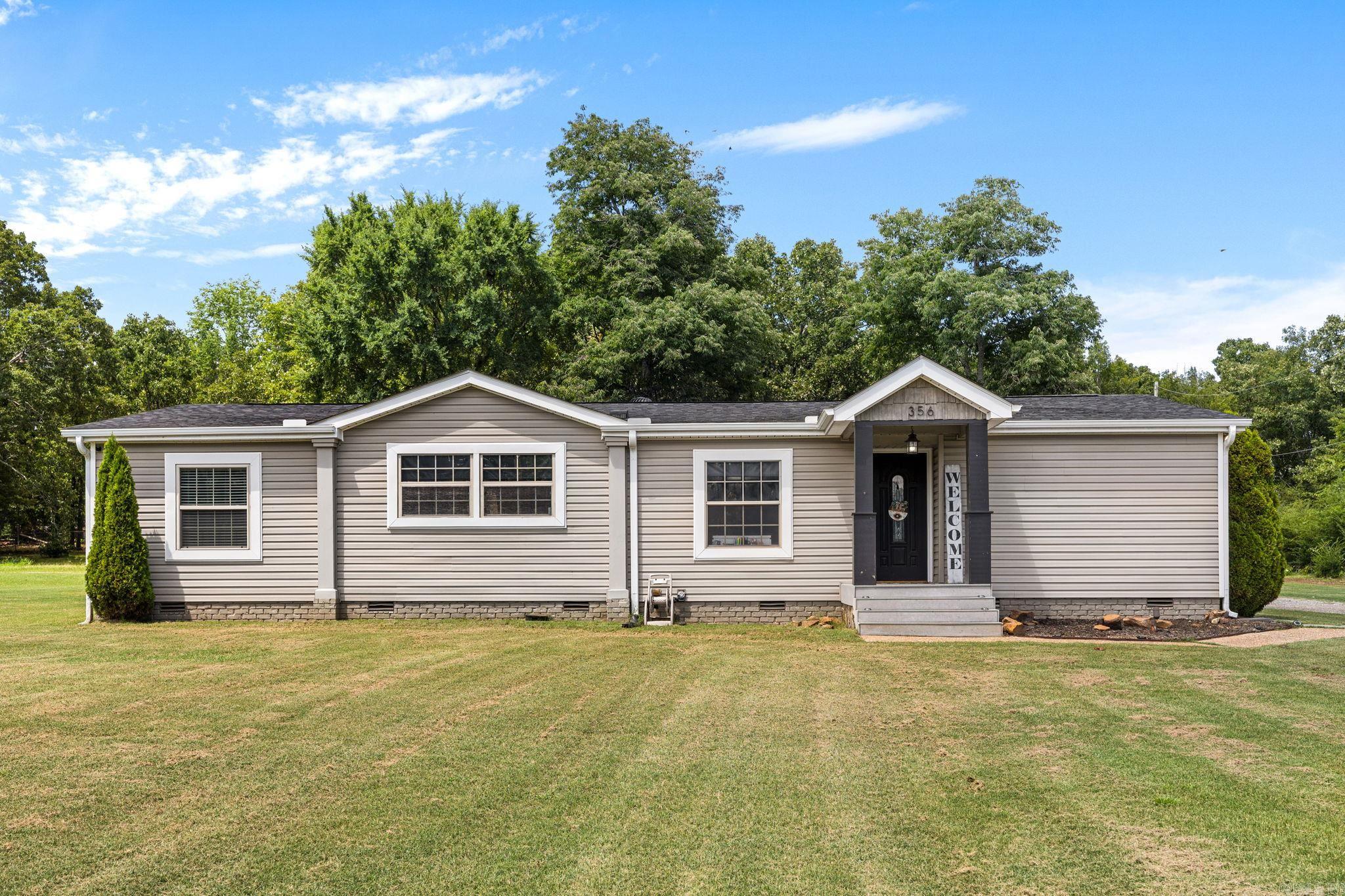If you've been searching for the perfect blend of modern updates and timeless farmhouse charm on acreage, your search ends here! This 3 bedroom, 2 bath home offers 1,568 sq ft of beautifully updated living space filled with custom farmhouse touches throughout. Step inside to a spacious living room featuring rustic wood accents, built-ins, and a cozy fireplace. The formal dining room flows into the stunning kitchen complete with newer stainless steel appliances, butcher block countertops, farmhouse sink, custom pull-out cabinetry, center island, and a large walk-in pantry. The spacious primary suite offers a relaxing soaking tub, oversized tiled walk-in shower, and plenty of room to unwind. You'll also love the oversized laundry room featuring abundant cabinetry and storage. Outside, enjoy peaceful country living with a circle drive, covered back patio, detached shop, and plenty of room to spread out on 2 acres. Schedule your private showing today! **Agents see remarks!