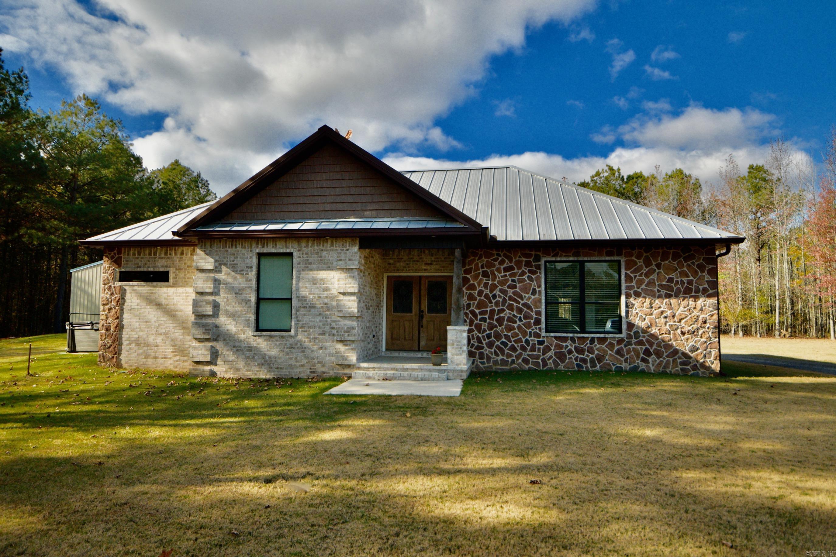 Looking for country living? Then look no further! This 2 bedroom 2 bath home has an open floor plan, cozy up in the living area with a gas fireplace,crown molding, 9 ft ceilings, nice kitchen with granite countertops, gas cooktop, double wall oven, breakfast bar, large walk-in pantry & lots of walnut cabinets, primary bathroom has a separate stand-up shower, large tub, double sinks, hall bath has a nice walk-in shower, luxury vinyl flooring throughout. Outside you'll find a 1080 sq ft shop house with 2 bedrooms and 1 full bath. Bring your livestock or just enjoy the abundance of wildlife. All this sitting on 40 acres. This one is a must see!  See agent remarks!