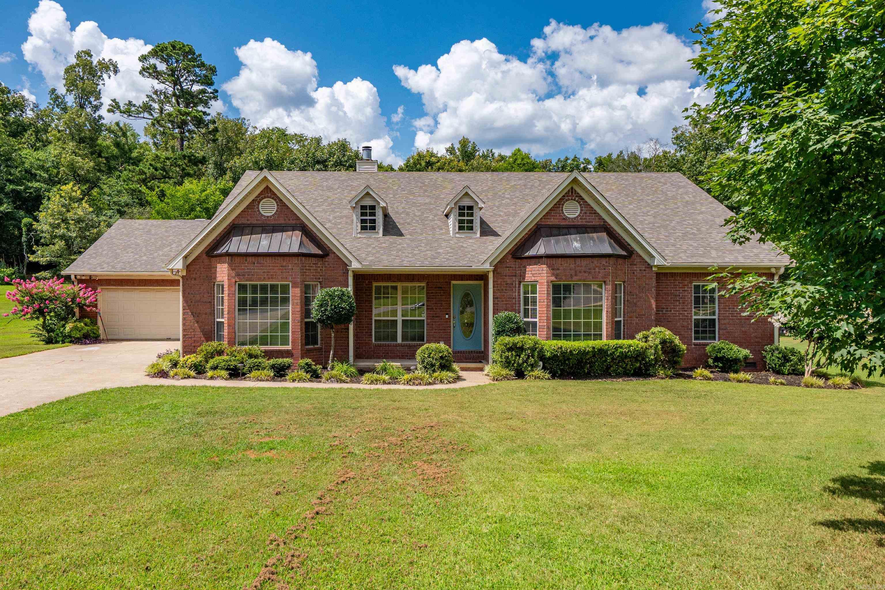 WELCOME TO 126 BAY RIDGE LOOP in Hot Springs, Arkansas. Escape to your own private backyard oasis featuring an in-ground pool, durable Trex decking and a relaxing screened-in porch, think 'entertaining' enjoying peaceful Arkansas evenings.  Located in a established neighborhood near Lake Hamilton. The beautifully renovate kitchen is sure to impress with quartz countertops, custom Craftsman soft-close cabinetry, under cabinet lighting, illuminated upper display cabinets, a gas range, double ovens including an air fryer and a convenient pot filler. The thoughtfully designed floor plan includes a private mother-in-law suite with a spacious bedroom and walk-in shower, for guest or multigenerational living.  The oversized laundry room provides abundant storage and workspace.  RECENT improvements: new flooring, fresh paint, updated light fixtures, and a 2023 roof. More features include a cozy gas fireplace, hot water recirculation system, sprinkler system, workshop space in the garage, a a storage shed with keyless entry. Pool equipment will convey with the home. Conveniently located near Lake Hamilton, shopping, dining, and everything Hot Springs has to offer, this home combines beautif