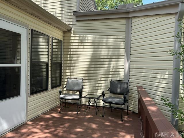 Enjoy this partially furnished condo tucked among the trees, offering comfortable indoor spaces and inviting outdoor areas for year-round relaxation. Unwind on the front deck in the park-like setting, or step into the sun room for a quiet transition between outdoors and indoors. The spacious living room includes a remote-controlled electronic fireplace with multicolored flame settings and optional heat for cool fall and winter mornings or evenings. The efficient kitchen opens to a dining area beside a bright window, making daily meals and entertaining easy. Two bedrooms provide flexible space for sleeping, working, crafting, or hosting guests. A stacked washer and dryer are conveniently located in the hallway, and a pull-down hallway door leads to attic storage with built-in shelving. Fairfield Bay town center is within easy walking distance, and nearby amenities include a marina, three pools, two golf courses, bowling, miniature golf, disc golf, pickleball, tennis, restaurants, shops, festivals, and more.