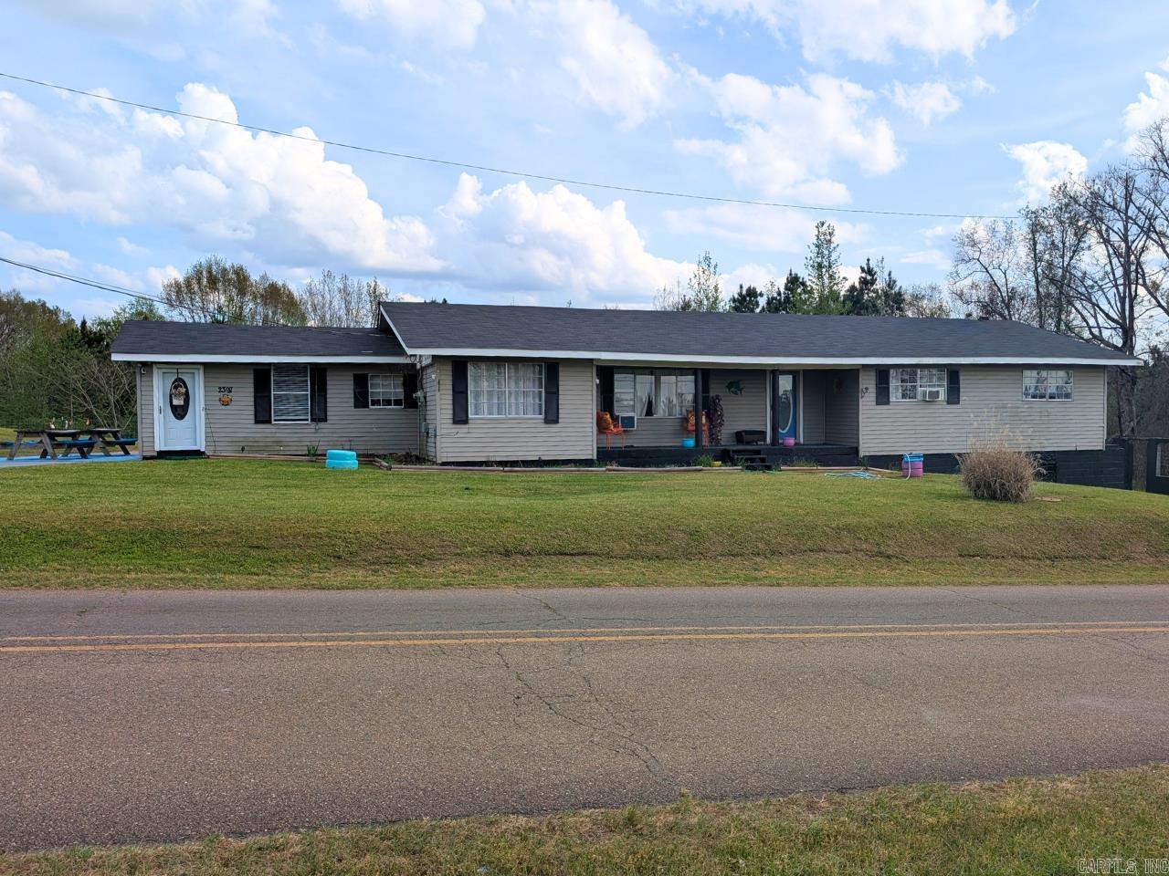 This sprawling 2,493 sqft ranch home is nestled on 4.43 acres on the outskirts of town. The property boasts 4 bedrooms, 2 updated bathrooms, a laundry room, beauty shop, and a bonus sunroom with access to the back patio. The inviting front porch is the perfect place to relax after a long day. There is a fenced garden area for planting your own fruits and vegetables. Beautiful flowers are planted around the property to welcome spring. You must see to appreciate this immaculate, well-designed home! Lot size, square footage, & acreage taken from courthouse records.
