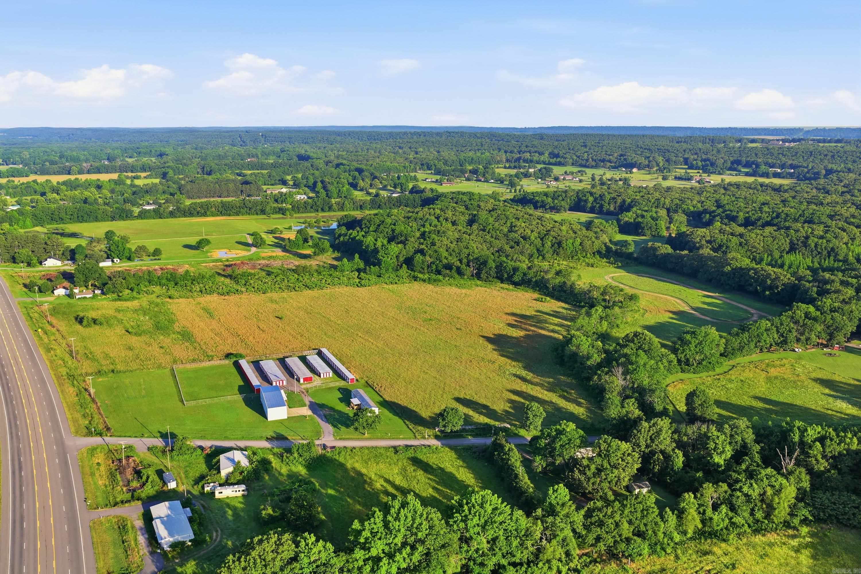 12 Cleared Acres with Highway 64 Frontage & Excellent Visibility! Located just over the Faulkner County line in El Paso, Arkansas, this 12-acre tract offers outstanding exposure and easy access for a variety of commercial or industrial uses. Surrounded by established businesses, including a storage facility, RV dealership, used car lot, metal fabrication shop, and other growing enterprises, this property is positioned in an area with new business growth. The property features two potential access points from Highway 64 and Blakemore Road, providing flexibility for future development and traffic flow. Currently zoned Industrial, the property may be eligible for rezoning to accommodate your specific business needs. Whether you're looking to expand, invest, or build from the ground up, this highly visible location offers tremendous potential. New survey coming soon! Great location. Great visibility. Great opportunity! Call us today!