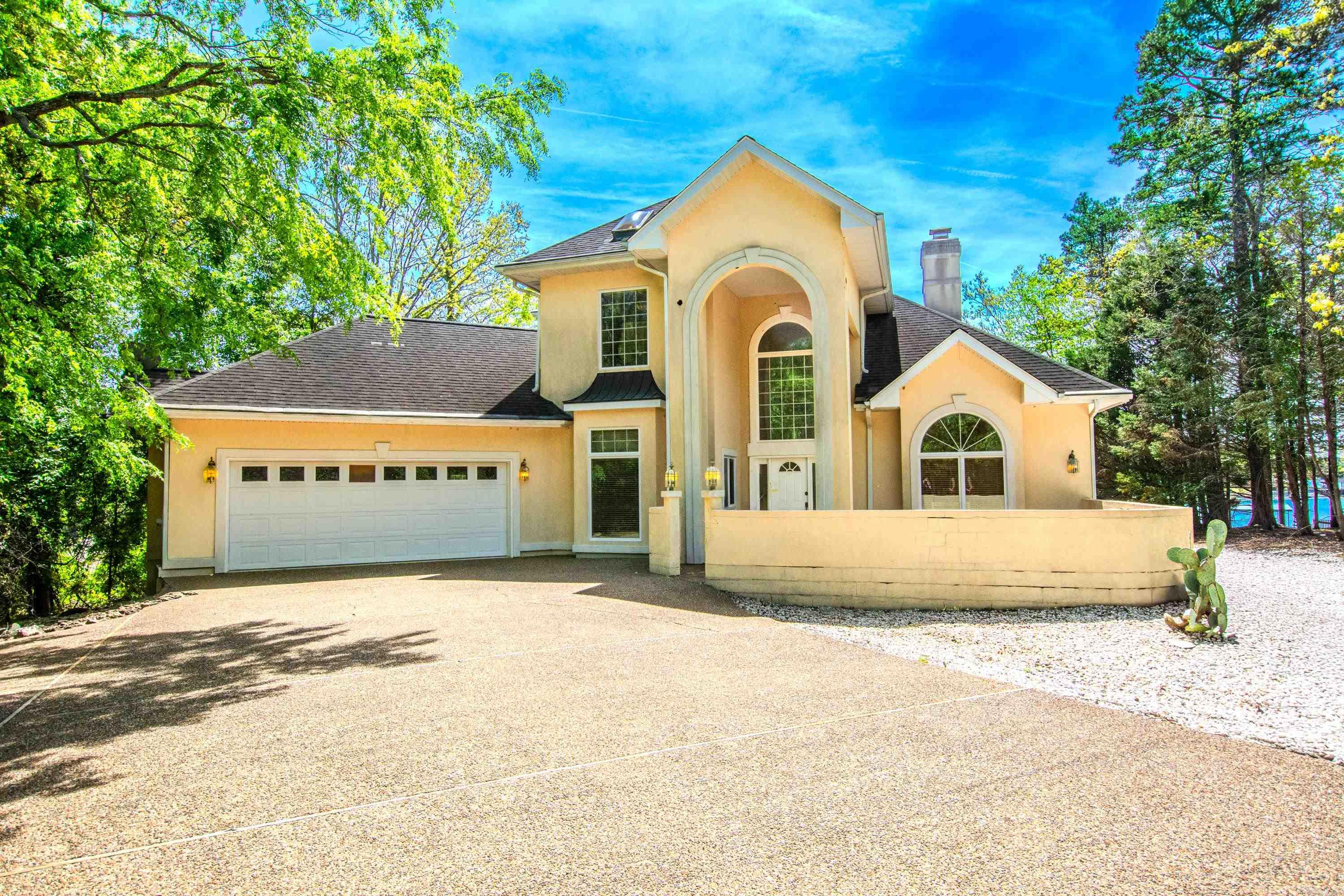 Stunning Lakefront Retreat on a Quiet Cul-de-Sac Wake up every day to an unforgettable panoramic lake view in this beautifully appointed lake house, perfectly positioned on a peaceful cul-de-sac. Designed for both relaxation and entertaining, this home blends timeless comfort with elevated custom finishes throughout. Property Highlights Expansive lake views from the main living areas and primary suite Private dock with space for two boats—ideal for lake lovers and weekend adventurers Two fireplaces offering cozy ambiance Deck off the primary suite, perfect for morning coffee or sunset unwinding Custom master closet with thoughtful organization and premium craftsmanship Solid brass, high-end bath fixtures adding luxury and durability Custom drapes and blinds throughout the home for a polished, designer feel Gourmet Kitchen A chef-ready kitchen featuring: Custom cabinetry with abundant storage Profile double oven for effortless hosting JennAir stovetop for precision cooking Located in desirable Hot Springs with all that has to offer  disclaimer, some photos virtually staged
