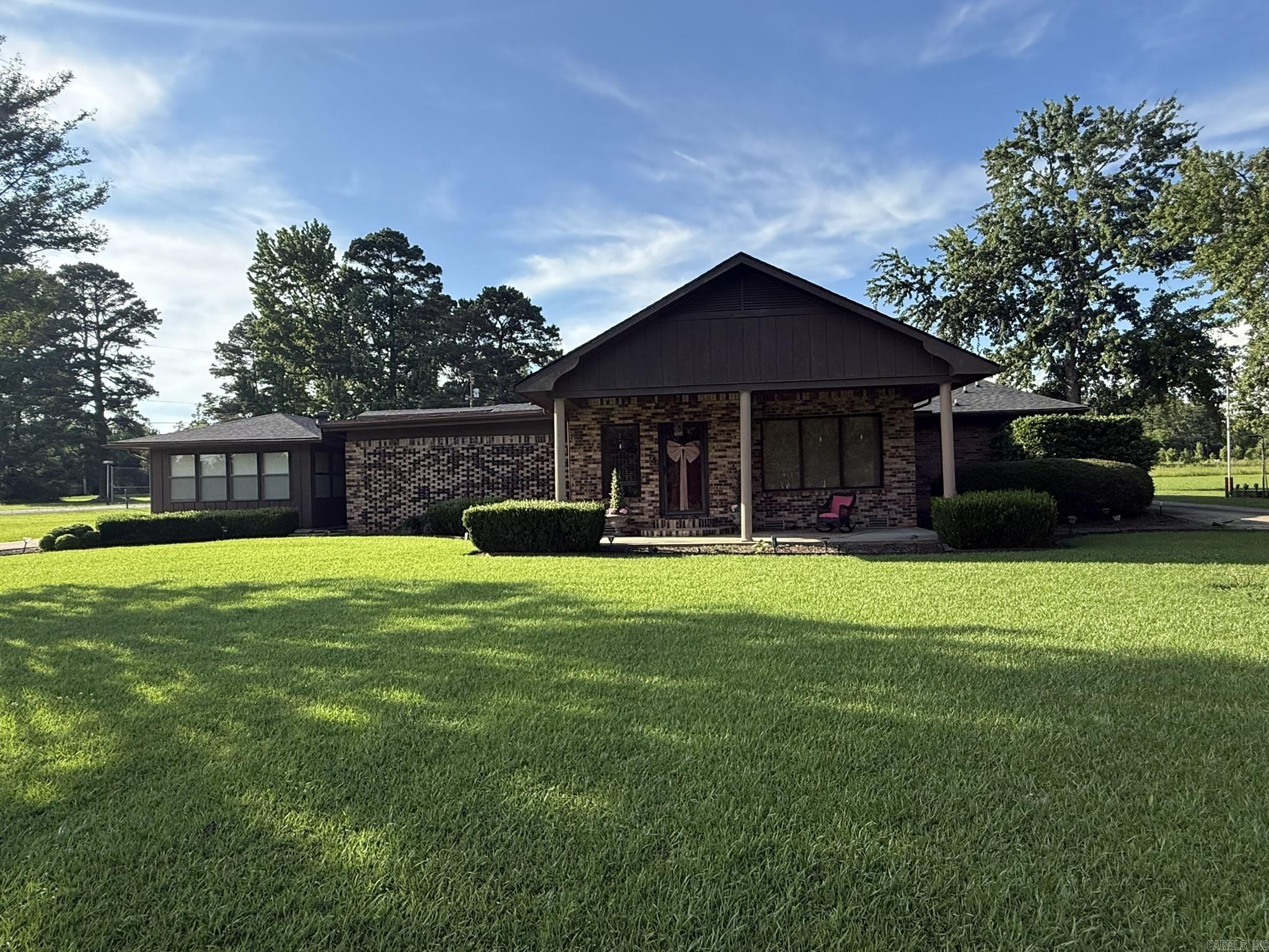 Welcome to your own private retreat on 3.6 beautifully landscaped acres! This stunning 2,960-square-foot home offers an incredible combination of space, comfort, & amenities that are hard to find. Designed with entertaining in mind, the home features an open floor plan with multiple living spaces, including a formal living room, formal dining room, & a spacious great room with a gas fireplace. The kitchen is the heart of the home, showcasing granite countertops, a large island, & abundant cabinet storage. The master bedroom is truly exceptional, featuring a professionally designed spa-inspired bathroom complete with a steam shower, oversized soaking tub, bidet, & luxury finishes throughout. Step outside & enjoy everything this property has to offer. The grounds include a tennis court, covered patio, two concrete driveways, three storage buildings, & a two-car carport connected to an RV shed that serves as the perfect covered space for entertaining, cookouts, & gatherings. Recent updates provide added value & peace of mind, including a new roof in 2023, central heat & air replaced in 2020, & complete rewiring in 2020.