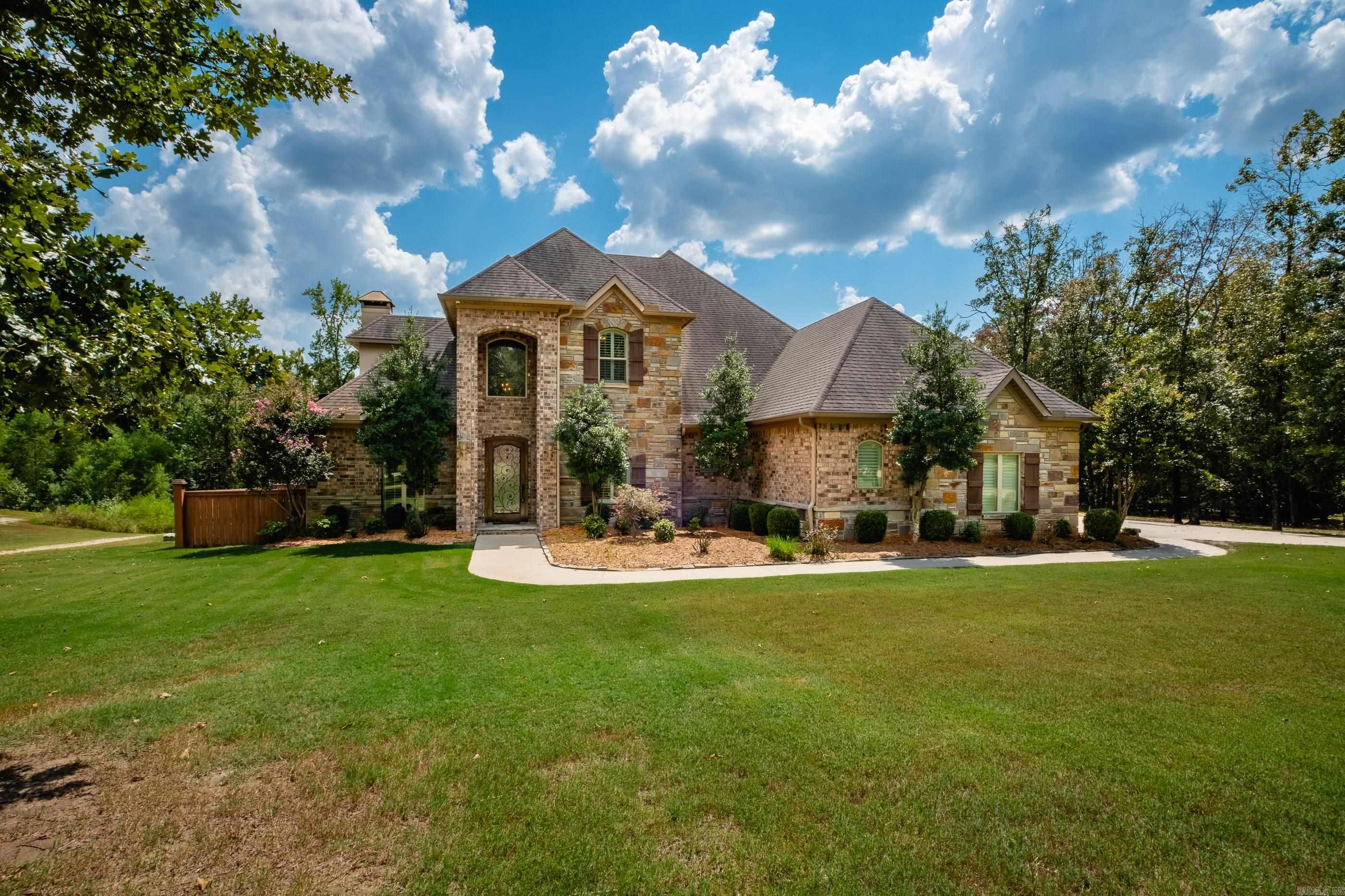Exceptional home on 5 acres in the Westcliffe subdivision.  This home has a deck overlooking large pond.  Covered porch has views of oversized pool with diving board area, sport court area, hot tub and sunbathing area.  Main level boasts arched brick openings, dining room, office with coffered ceiling, hearth room has oversized fireplace with open kitchen.  Main level primary bedroom with sitting area and large luxurious bath.  Upstairs has two bedrooms with shared bath.  Additional bedroom with hall bath that shares with bonus room (this could be 5th bedroom) and balcony overlooking pool.  Fenced area for dogs.  Home has three car attached garage.  Separate detached garage/workshop 1546sf with room for 7-8 cars or drive your boat through front and back garage doors.  Efficiency apartment/in-law quarters with full kitchen, full bath, laundry and storm room.  This has it all.  Come see!