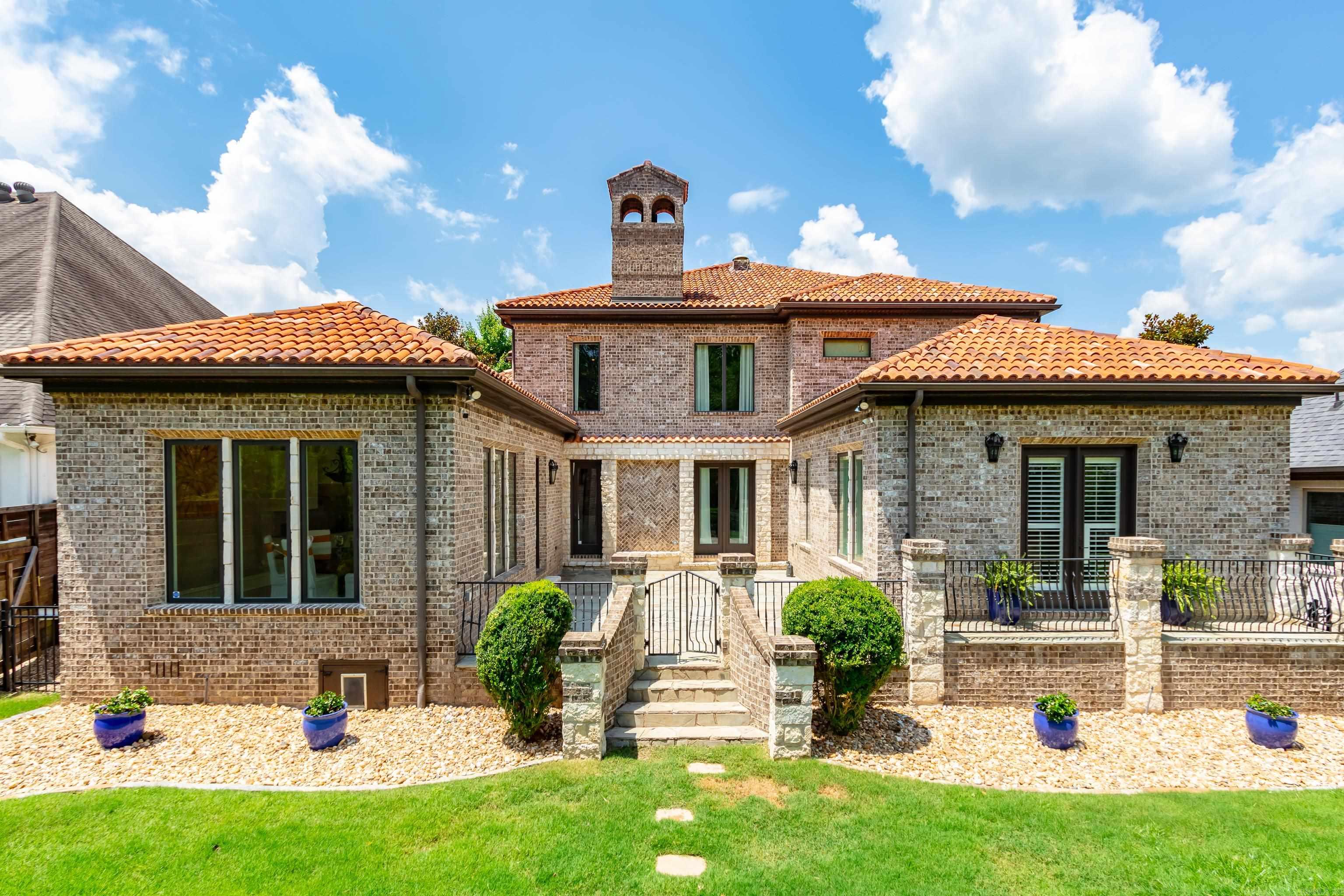 24hr notice to show: This beautiful home has custom architectural detail that will amaze you! Two story great room with arched detail, dining with full-service bar, gourmet kitchen- heavy granite counter tops, double oven, and your very own wine cellar! An awesome custom movie theatre with remote controlled window covers 2-bedroom suites & open loft upstairs. Guest suite and Primary suite located downstairs! The Primary bedroom boasts cherry wood floors, sitting area, private patio access, 2 showers (1 steam) & jacuzzi tub with attached walk-through laundry. Large walk - in closets! Enjoy outdoor entertaining on stone patio/courtyard that overlooks fenced yard with a creek and permanent green space for privacy, Custom Real Wood window blinds, remote controlled window coverings! Automatic blinds in theatre room. **HOME WARRANTY**