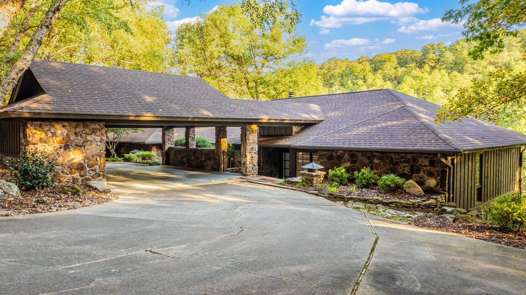 Nestled on 5 pristine acres in Robinwood, this extraordinary estate is a refined, intimate escape. Secluded down a private, tree-lined drive, this soft-contemporary masterpiece has been meticulously reimagined, with luxurious, modern finishes that radiate sophistication.Step through the custom iron-and-glass entryway, where vaulted ceilings, a double-sided fireplace, & a wall of floor-to-ceiling windows create a breathtaking ambiance.The open-concept design seamlessly blends into the surroundings, perfect for entertaining or intimate evenings.The gourmet kitchen is a chef’s dream, featuring top-tier appliances, breakfast area, & an adjoining butler’s pantry.The main level also boasts a formal dining area,2 spacious berms with a designer bath, and a primary suite—a spa-like retreat with walk-in shower, a stunning closet with a laundry hookup, & ultimate tranquility.The stylish lower level offers 2 additional bdrms, a home office/gym, a second laundry room, & a sleek wet bar, all complementing a second living space.Escape to the expansive deck, where breathtaking views & unmatched privacy await. A two-car porte-cochère, whole-home generator& flawless design complete this showstopper.