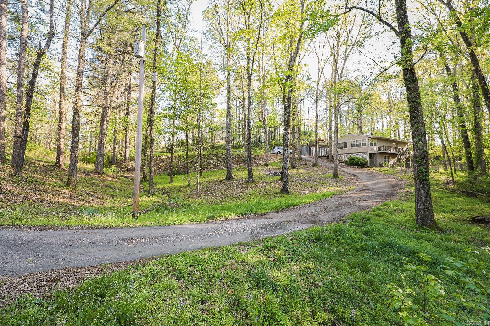 Country setting yet conveniently close to town, this charming home offers the best of both worlds. Situated on a little over an acre of land, this property has four bedrooms and two baths, providing ample space for comfortable living.There is a versatile flex space, perfect for accommodating your unique needs and preferences. Whether you envision it as a home office, a playroom for the kids, or a large walk in closet, the possibilities are endless. Additionally, you'll find a screened-in front porch, where you can relax and soak in the peaceful surroundings while enjoying the fresh air. The fenced-in front yard provides a safe and secure space for your pets to play freely. For added convenience, there is a storage building on the property, offering the space to store your outdoor equipment, tools, and more. If you're searching for a home that offers tranquility, space, and convenience, this property may be just what you're looking for.