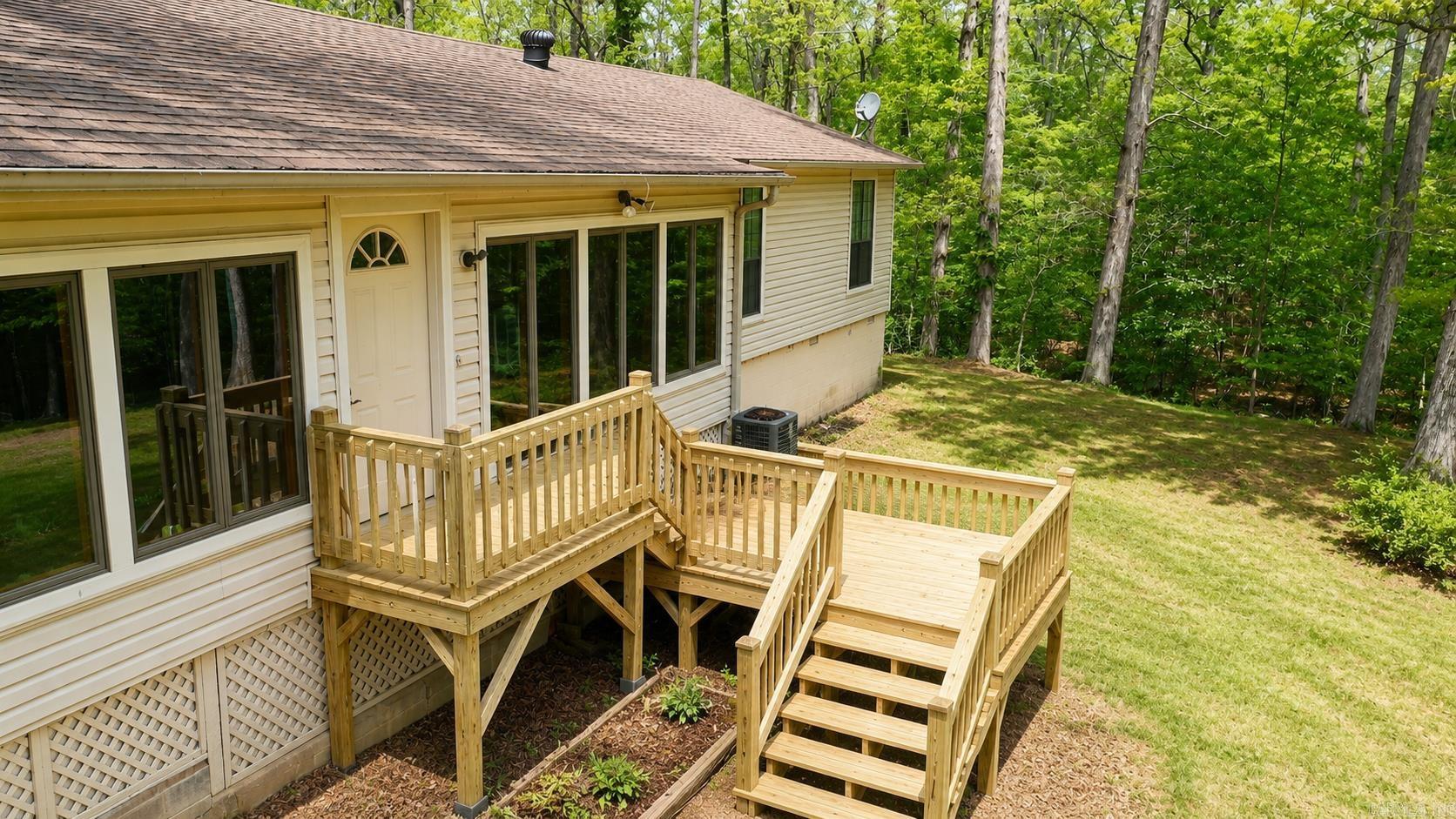 Perfect getaway near beautiful Lake Ouachita in Mount Ida, AR! Whether you're looking for a full-time residence, vacation home, or an income-producing VRBO, this property checks all the boxes. This move-in ready home has been thoroughly cleaned, including all carpets, and is ready for its next owner. Inside, you’ll find two spacious living areas, including a stunning enclosed sunroom with a wall of windows overlooking access to Twin Creek—perfect for relaxing and enjoying the natural surroundings.  Property has easement to access Twiin Creek with trails, creek access and wildlife. The home features two bedrooms and two newly remodeled bathrooms, along with a convenient side-entry mudroom with storage and a separate laundry room. Outside, the property offers a carport with three storage areas, providing plenty of space for tools, lake gear, or hobbies. A separate bunkhouse adds even more versatility—ideal for guests or additional rental potential. Don’t miss this opportunity to own a slice of paradise near Lake Ouachita