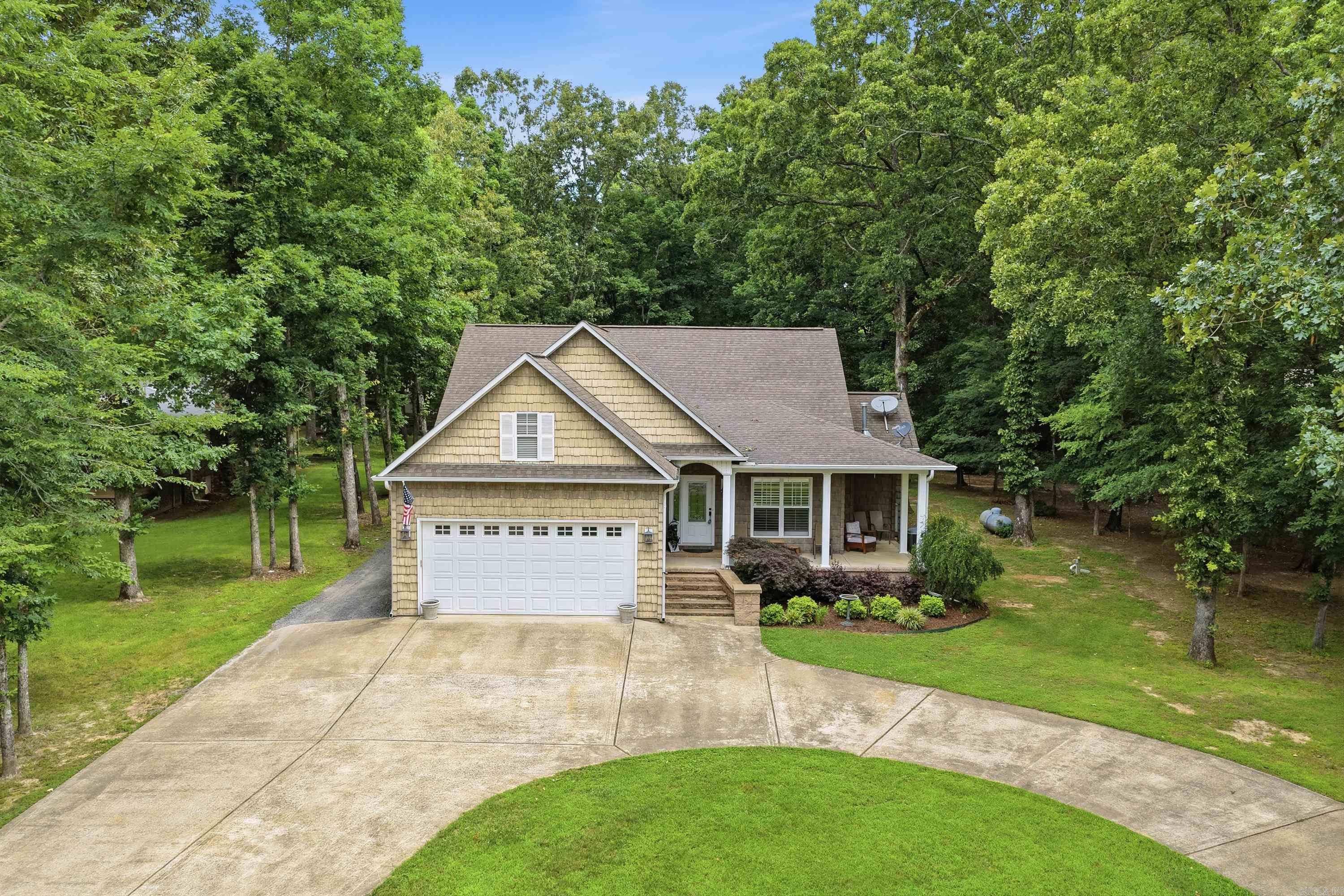 Come checkout this home located in one of the most desirable neighborhoods on Greers Ferry Lake.  This home has 3 Bedrooms, 2.5 baths all on one level. NEW FLOORING installed this month (June) throughout the living room, kitchen, laundry room, & hallways. There is a bonus room over the attached garage that could easily be finished out as more heated & cooled space since the duct work for the HVAC is right there (could be great for a game room or another guest bedroom). The 24x30 insulated shop also has a 1/2 bath. Living Room has vaulted ceilings with a gas-fireplace. Kitchen comes with granite countertops, stainless steel appliances, & custom display cabinets. Family-friendly screened in porch off the kitchen that walks out onto the back deck where there is a wood-burning stone fireplace, outdoor sink, covered pavilion & a nice size backyard. Granite countertops in kitchen & bathrooms.
