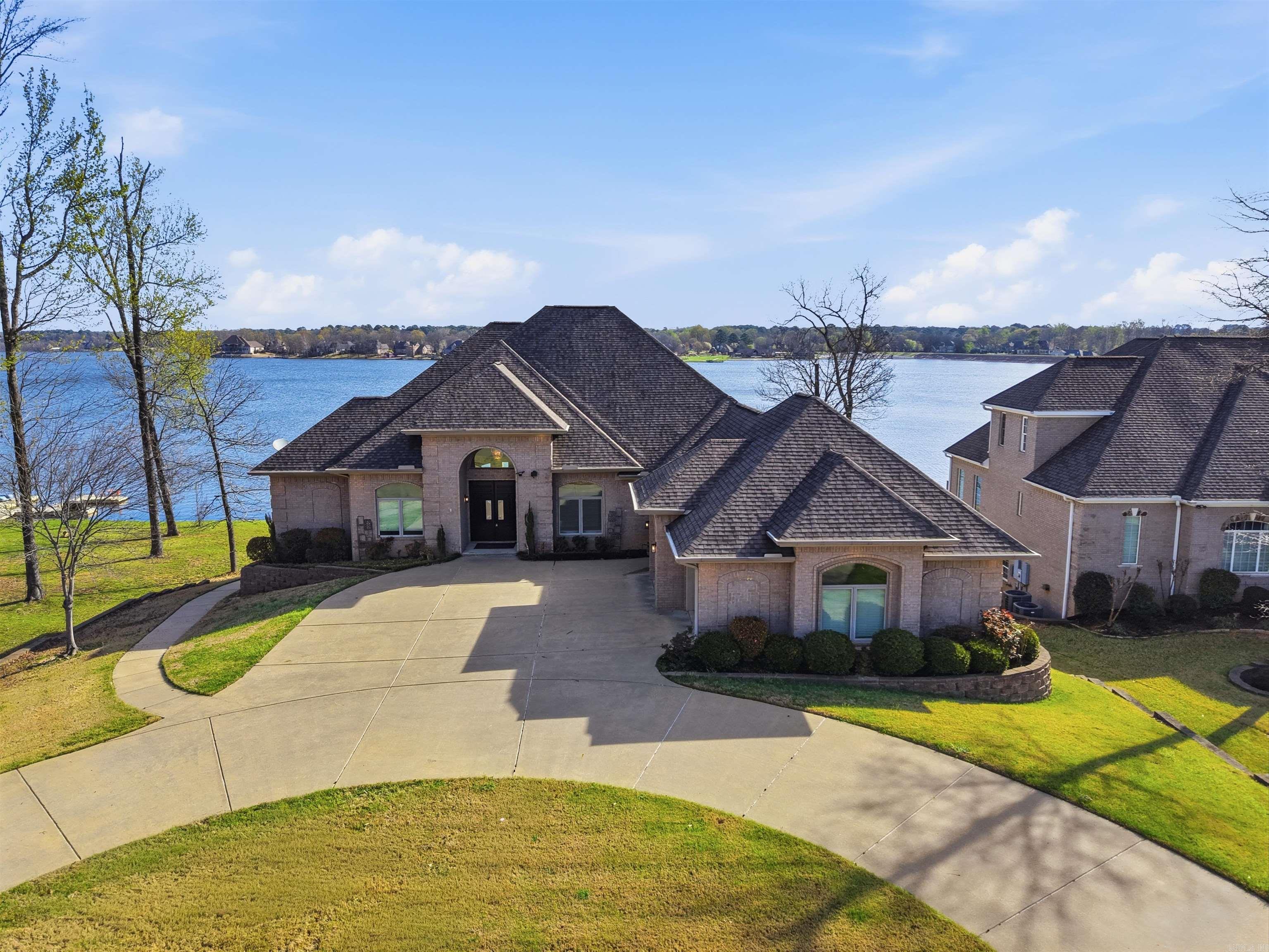 PRICE IMPROVEMENT + NEW OPPORTUNITY!  Strategically repositioned to reflect today’s market and create exceptional value in desirable Hurricane Lake Estates! 5918 Riviera Dr offers over 5,000 sq ft of luxury living with spacious entertaining areas, upscale finishes, beautiful natural light, and breathtaking views throughout. Thoughtfully designed floorplan with oversized rooms, a stunning kitchen open to the main living area, and a private primary suite retreat. Outdoor spaces are perfect for relaxing or entertaining while enjoying the lake lifestyle buyers love. Seller is also offering 5k concessions, helping make this home even more attractive for buyers wanting assistance with closing costs or rate buy-down options, or even their own finishing touches. Fresh pricing + added incentives = renewed buyer opportunity. Premium features include a private elevator, whole-home generator, safe room, and water filtration system. Enjoy outdoor living with fully landscaped backyard, EZ floating dock, and waterfront views. Recent updates include a bath remodel, sprinkler system, and tankless hot water heater. Don’t miss your chance to own in one of Benton’s most sought-after gated communities!
