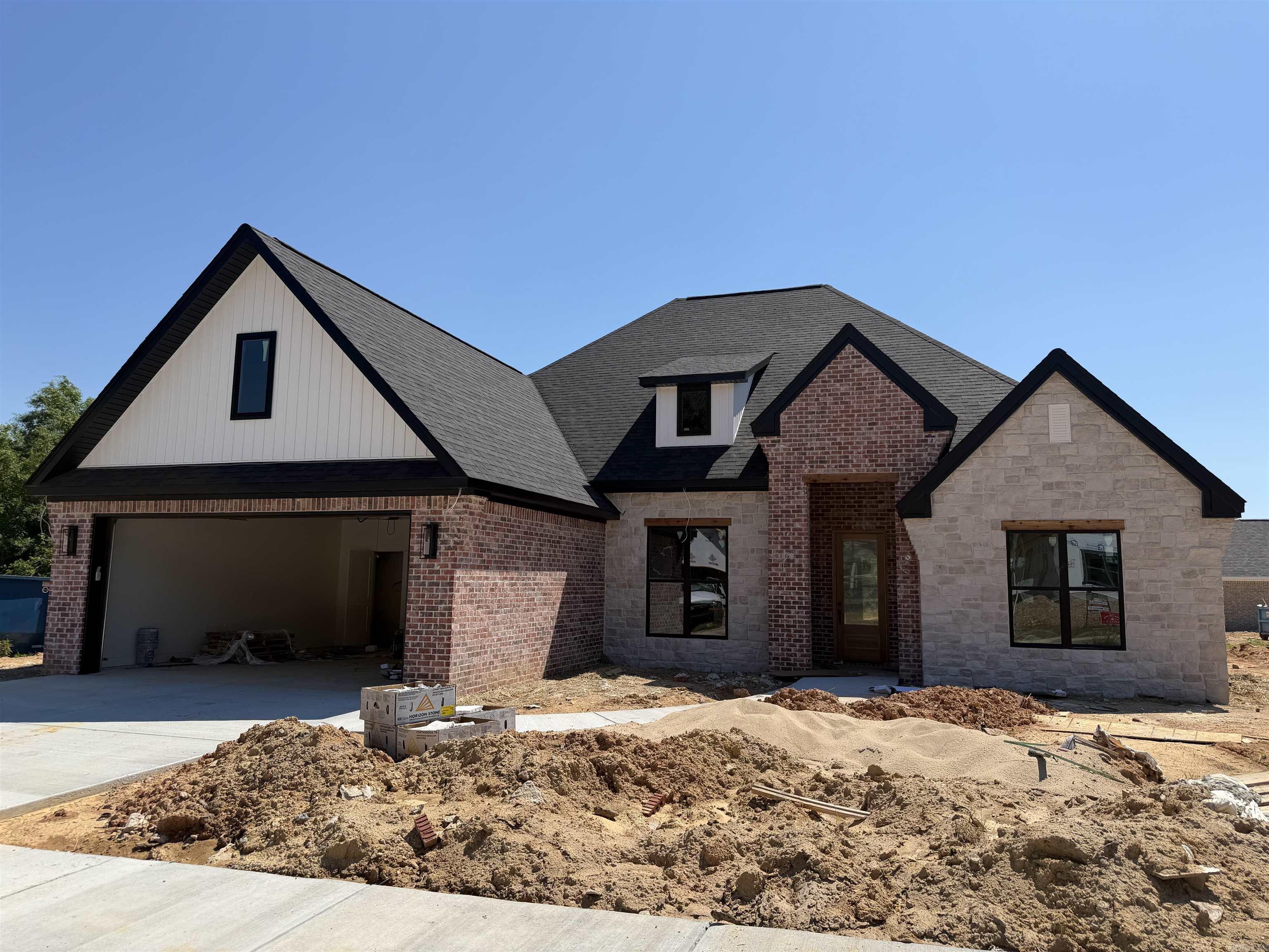This new construction in Creekside offers 4 bedrooms, 2.5 baths, and the perfect mix of traditional charm and modern style. Tall ceilings, custom finishes, and an open layout make the home feel bright and welcoming. The kitchen features custom cabinets, beautiful countertops, a gas stove and flows into the living room, where a centrally placed gas fireplace creates a cozy focal point. The split floor plan offers privacy, the primary suite is spacious, and there’s plenty of storage throughout. Enjoy a covered patio and nice backyard in one of Bryant’s most sought-after neighborhoods. Come see today!