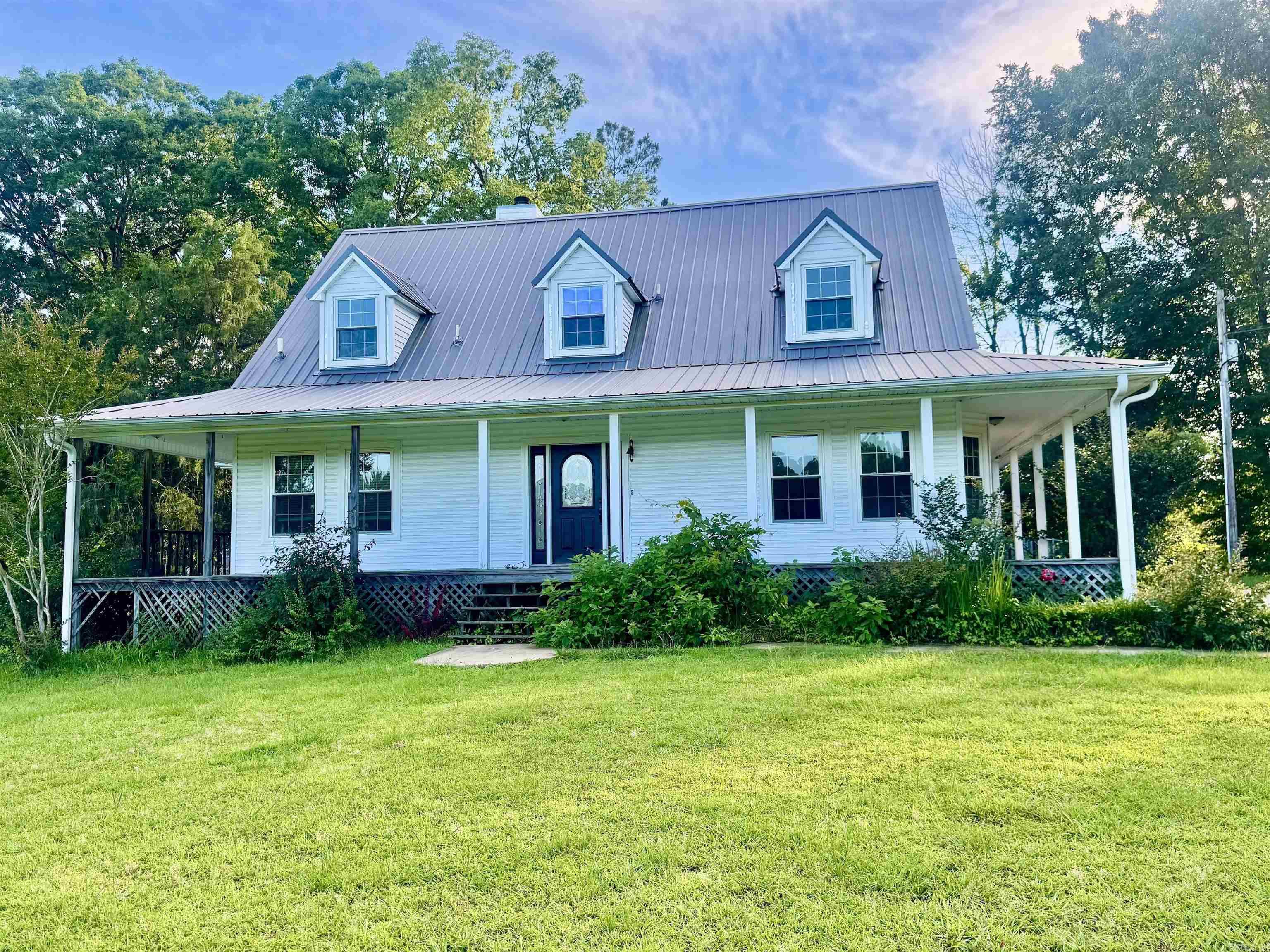 Charming country retreat on 9.71 acres offering the perfect blend of privacy and convenience, just minutes from town! This beautiful 3-bedroom, 2.5-bath home features spacious living areas, comfortable bedrooms, and plenty of room to enjoy peaceful rural living. Step outside to your own backyard oasis with an in-ground pool, ideal for relaxing or entertaining family and friends. The picturesque front pond adds to the property's natural beauty and provides a serene setting to enjoy year-round. With nearly 9.71+ acres of land, there's ample space for recreation, gardening, animals, or simply enjoying the wide-open countryside. Experience the tranquility of country living without sacrificing easy access to shopping, dining, schools, and other local amenities. Don't miss this rare opportunity to own a private slice of paradise with acreage, a pool, and a pond—all in a highly desirable location close to town!