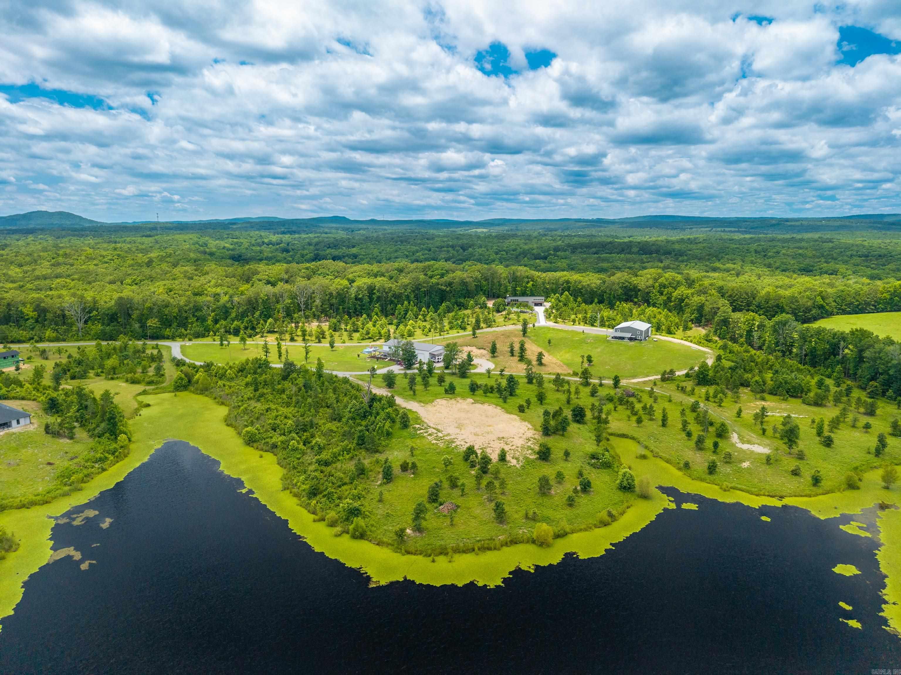 Embrace the charm of lakeside living in this hidden gem of a gated community, where tranquility meets exclusivity. This exceptional 7.12-acre lakefront lot offers a rare combination of natural beauty and usable space, with mostly level land and multiple flat building sites—ideal for building the private retreat of your dreams. Nestled along the peaceful shores of a small, pristine lake, the property provides an intimate setting perfect for those seeking a quieter, more connected lifestyle. Whether you're savoring your morning coffee with views of the water or exploring the land's generous acreage, this lot offers both serenity and potential. Enjoy direct lake access for paddleboarding, kayaking, or quiet moments by the water’s edge. The community itself is small and gated, fostering a close-knit atmosphere where neighbors become friends and nature is your everyday backdrop. This isn’t just a piece of land—it’s an opportunity to build a home that reflects your lifestyle in a place where privacy, peace, and natural beauty abound. Minimum 1800 sqft home required.