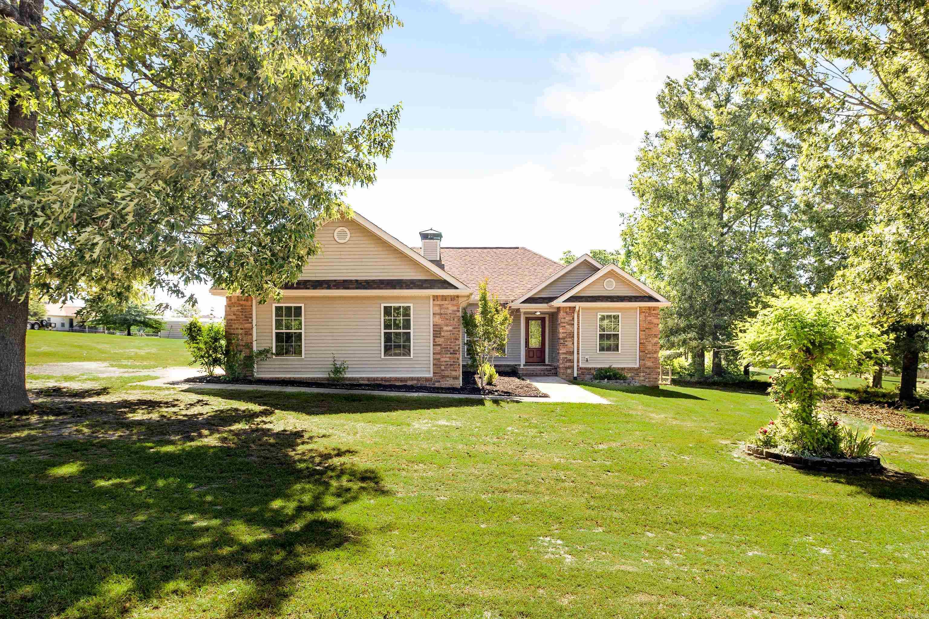 Welcome to 5315 Dew Trail! Situated on a RARE 1.55-acre lot, this move-in-ready home features FRESH paint, NEW luxury vinyl plank flooring, and NEW modern kitchen appliances. With a roof just two years old and a new hot water heater, you can enjoy peace of mind! This home checks all the boxes!! The level lot offers plenty of outdoor space, and the two-car garage provides ample storage. Enjoy hanging out with friends and family on your back porch or chilling by the fireplace on those cozy nights! Property is RD eligible.  Lot line drone photos will be added. Virtually staged.