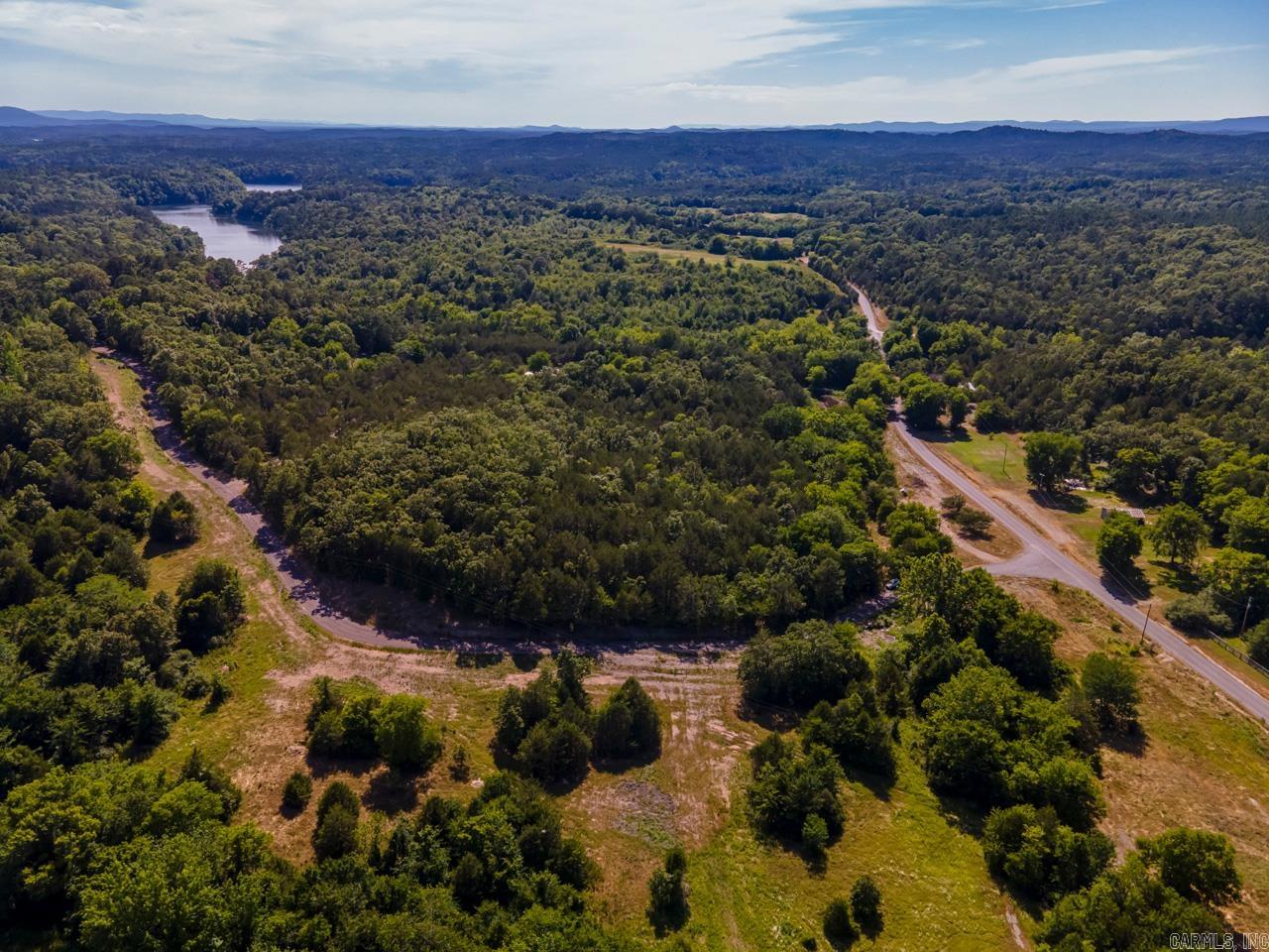 Amazing location just a couple minutes from the north shore marina. Perfect spot to get away and enjoy all that Lake Ouachita has to offer. 16 acres with gated driveway that has been graveled. The long drive leads to two building site pads that have already been built for you. The wooded acreage backs up to the national forest.