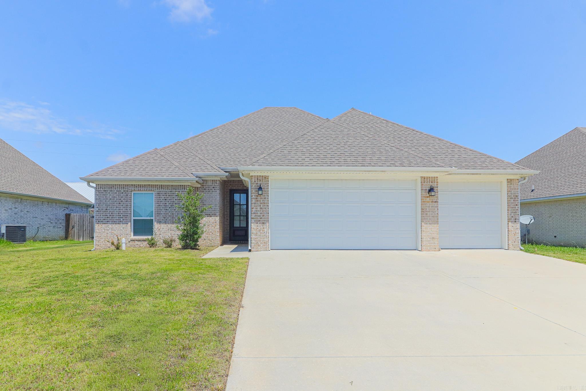 This home features an open living area with a cozy fireplace and a bright kitchen with white cabinetry, pantry style cabinet with custom pull-outs, stainless appliances, and granite countertops. Stainless gas oven/range, built in dishwasher, and built-in microwave finish out the open kitchen.  LVP flooring runs throughout the home, paired with tile in all wet areas for durability and easy upkeep. Enjoy a privacy-fenced backyard, recessed lighting, two interior storage closets, and additional double-door storage in the spacious 3 car garage. A small back patio completes this move-in-ready home.