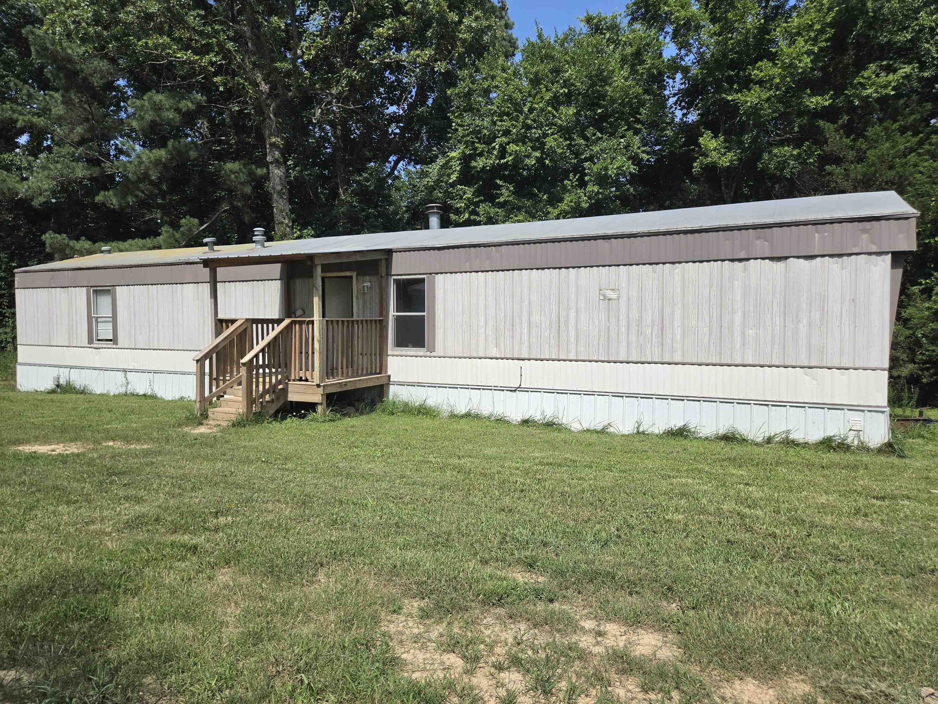 Investor special! Two homes for the price of 1! Sitting on a 1 shared acre across the street from each other. Currently open 2 bed 2 bath home includes wood burning fireplace, central heat and air plus wall propane heaters. Kitchen incl elec stove, dw and breakfast bar plus dining area hutches for storage. Large primary bedroom w/ walkin closet. Primary bath with garden tub. Front and back decks for entry. Shared well but each home has its own septic and propane tank. 2nd home currently occupied 3 bed 2 bath. Open kitchen-living-dining area incl gas stove, dishwasher, and fridge. Split floor plan w/primary bed and bath on opposite end of the home as main bath, laundry & 2 more bedrooms. Outside partially fenced area and plenty of parking space. No restrictions