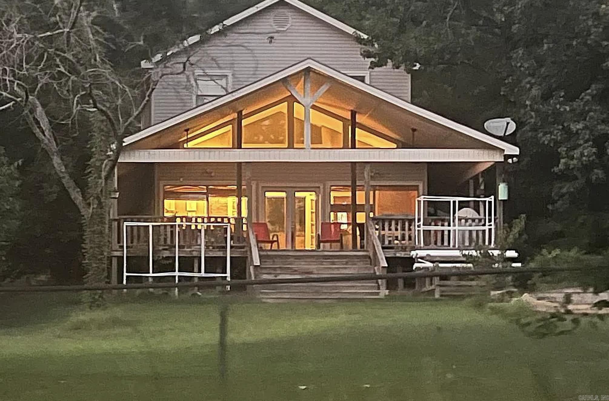 This rare lakefront retreat is located on the north end of Lake Conway, just five minutes from I-40. While the lake restoration project is underway, the future of Lake Conway is brighter than ever.  Built for both peaceful everyday living and entertaining, the home features 3 bedrooms, 3.5 bathrooms, and a brand-new roof (2025). Enjoy a bright, open-concept living room and a dedicated office space.  The updated kitchen has granite tile countertops, solid wood cabinetry, stainless steel appliances, and a large island. Relax in the sunroom overlooking the backyard and lake. A large Primary Suite features new laminate wood flooring and a jacuzzi tub. Upstairs you will find a game room with domed cedar plank ceilings, a pool table, bar area, and its own private bathroom. House has been wired by an electrician for a generator.  Exterior & Garage Amenities include: Fenced 0.6-acre lot with a wraparound covered porch, covered sunset-view deck, fire pit, and hydroponic garden setup. Waterfront Features: A newly resurfaced dock and a boathouse with a brand-new roof. Plenty of space in the 3-Car Garage equipped with a built-in workbench, half bath, and a built-in 6’ x 7’ steel storm shelter.