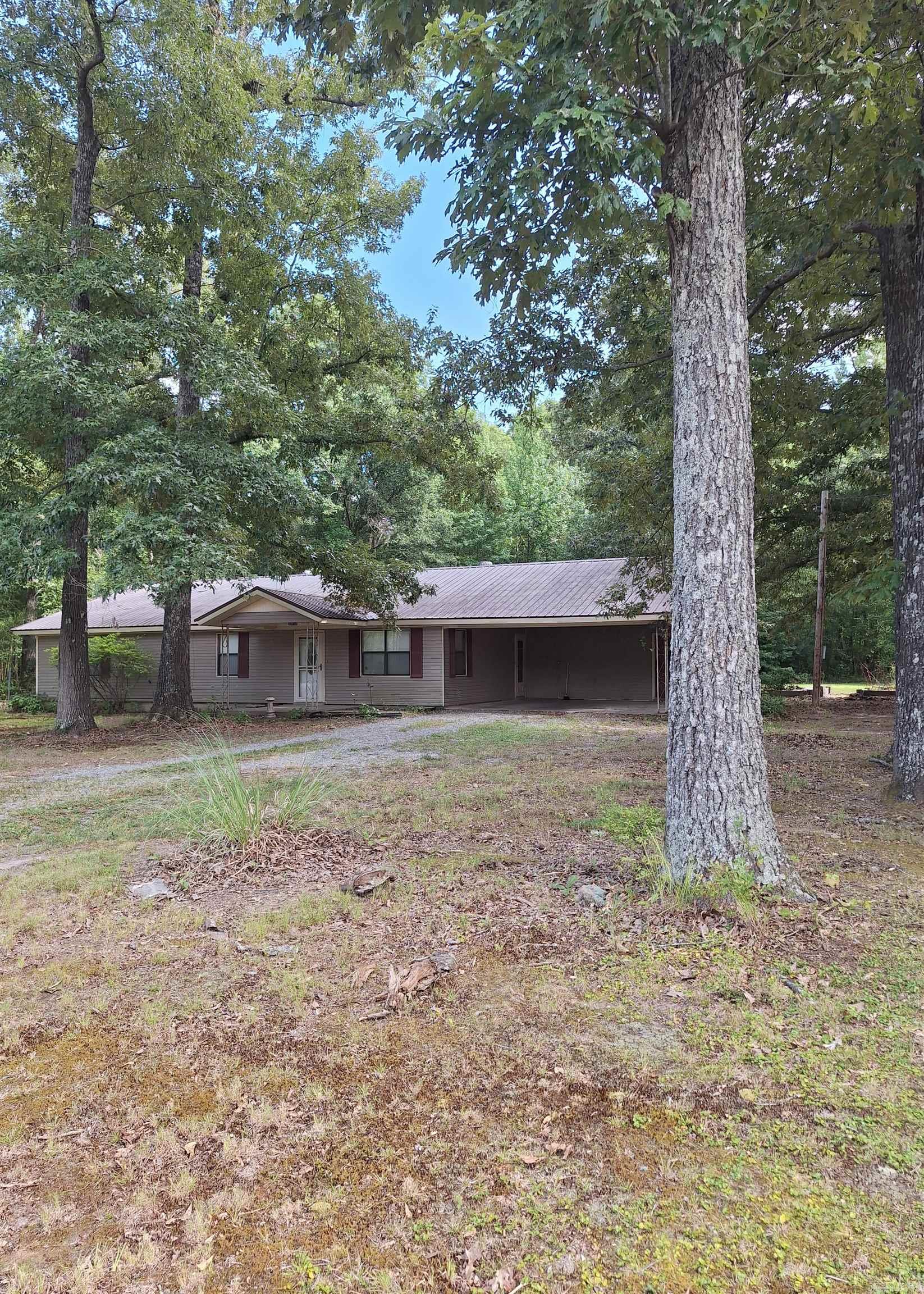 Storage galore in this 3 BR 2 bath home featuring large kitchen with an abundance of cabinets, stainless steel appliances and roomy dining area. Separate utility room with built-in pantry cabinets and broom closet.  Comfortable living area with large picture window to take advantage of natural light. Double carport also features storage area and attic access. Plenty of backyard room for outdoor activities, gardening or just relaxing to the sounds of nature from the woods beyond.  Stay cool and rest easy with metal roof, insulated interior walls and 4-ton Trane CH/CA. Handicap accessible and Rural Development Eligible give this home 2 additional pluses! AGENTS SEE REMARKS