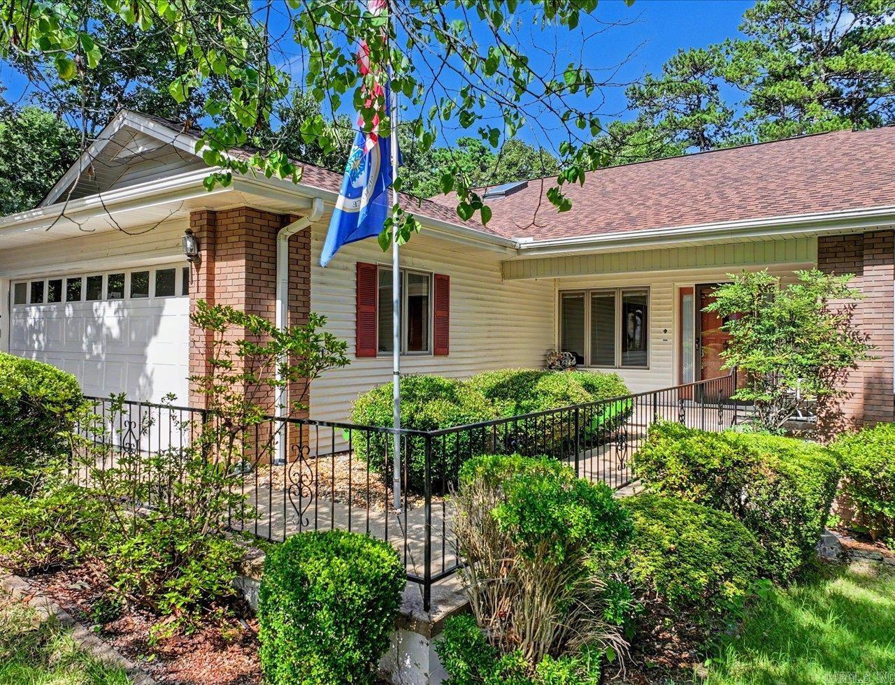 Located in the heart of Hot Springs Village, this 3-bedroom, 2.5-bath home with a dedicated office/den offers a spacious floor plan, abundant storage, and convenient access to the community's premier amenities, including golf courses, lakes, walking trails, fitness center, pickleball and tennis courts, restaurants, and marina access. A large wet bar provides additional space for entertaining.  The living room includes a gas fireplace and opens to a heated sunroom with expansive windows, creating additional year-round living space.  The primary suite features an en suite bath with a jetted tub, double vanity, walk-in shower, and oversized walk-in closet.  Major updates include a new roof 2025, HVAC system replaced two years ago, water heater replaced three years ago, and new kitchen appliances.  Enjoy easy access to Hot Springs Village's 11 lakes, 9 championship golf courses, miles of hiking and walking trails, recreational amenities, and nearby Lake Ouachita, Hot Springs National Park, and Ron Coleman Mining.  New Hot Springs Village property owners are subject to a $2,000 buy-in fee.