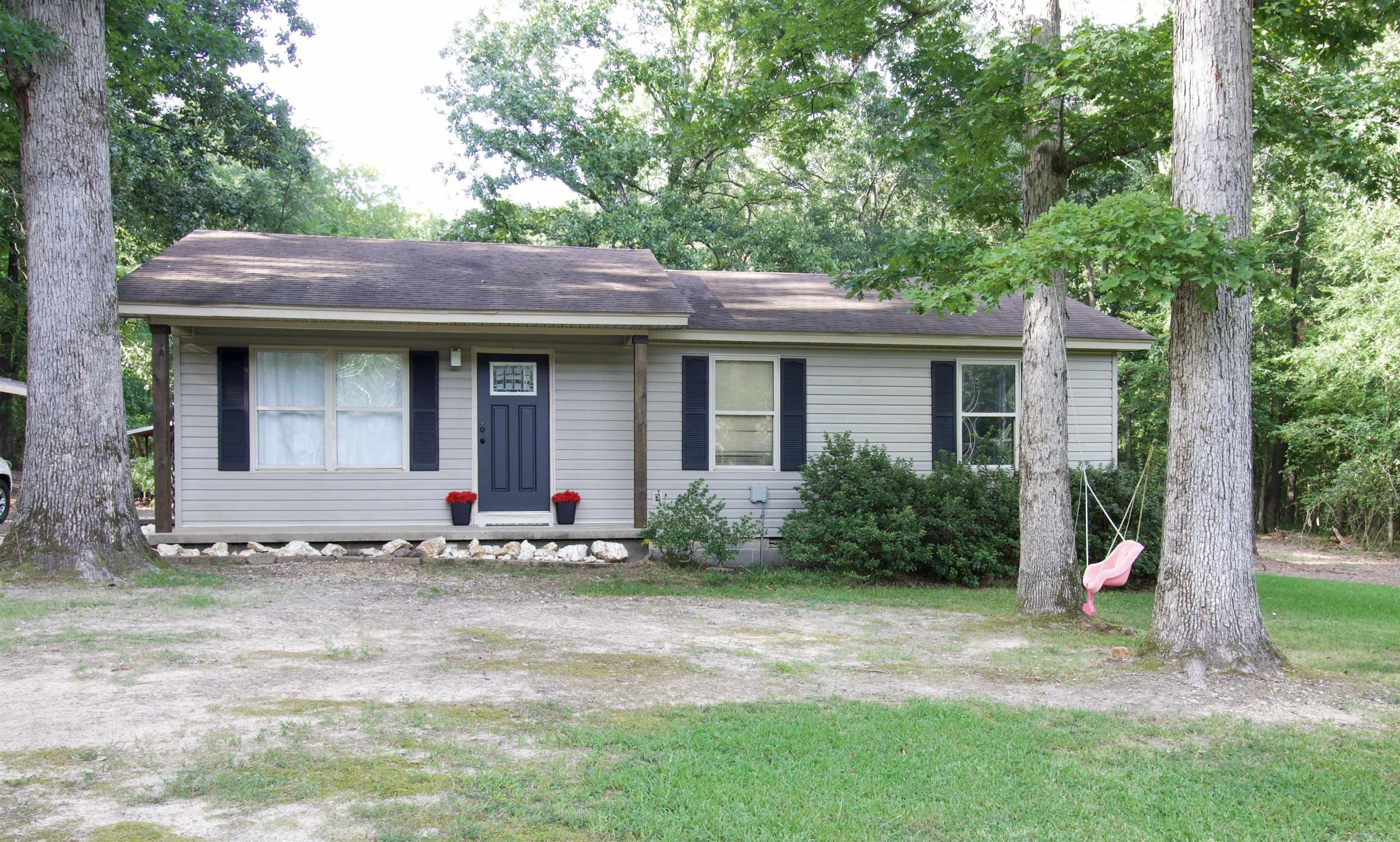 Come see this charming home on 1 acre! Perfect blend of country living with the convenience of being close to town. This 2 bed 1 bath has a bonus room currently used for extra storage that could easily be converted to a third bedroom. The cleared and level lot would be great for small livestock, gardening, or just a large place to entertain!