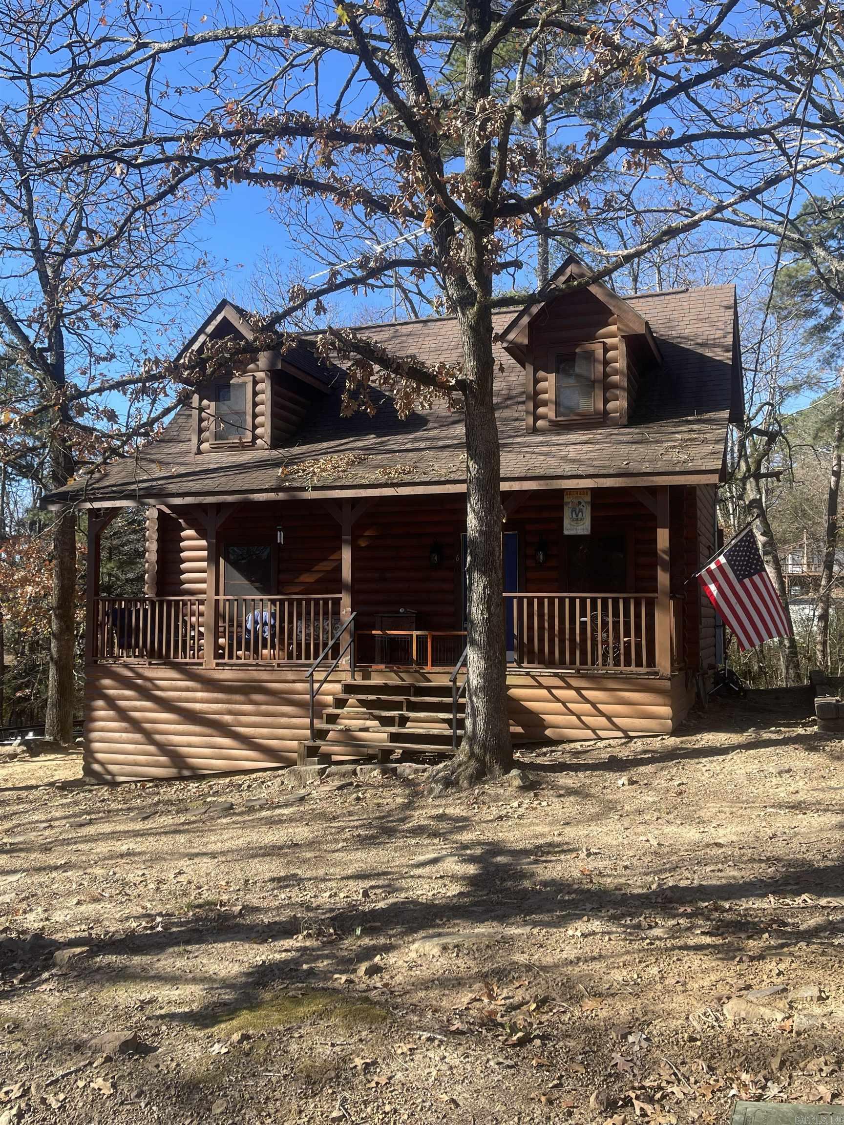 A true Abe Lincoln log home featuring 2 bedrooms, one up, one down, and 2 baths, one up with a walk-in shower, one down with a tub. Has a loft area upstairs with a closet that could be used for another sleeping area, living area, or home office. Storage area under front porch. A fire pit for enjoying time with friends and family. If you're looking for a weekend getaway, full-time home, or a vacation rental, this is it. Located between Greers Ferry and Fairfield Bay, so close to several different marinas, restaurants, and shopping. It's in the area behind the Edgemont Post Office. No restrictions.