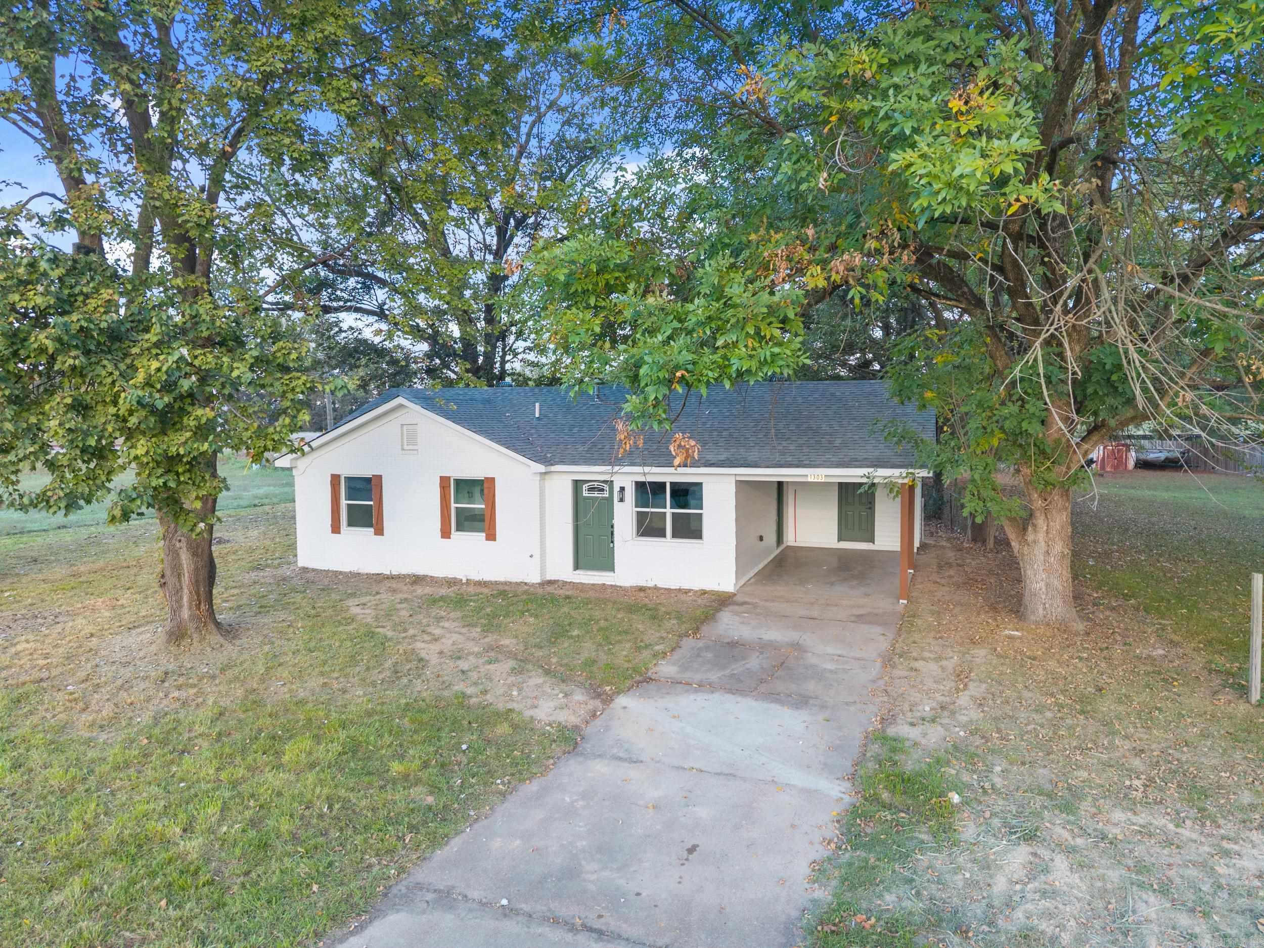 What a stunning remodel! It's amazing what all you get for this price! 3 bed/2 bath, all new luxury vinyl floors, paint, fixtures, appliances and so much more. Great curb appeal with painted brick and wood shutters.  The kitchen features beautiful granite countertops, painted cabinets, and new dishwasher, range/oven, and microwave.  Kitchen is open to the living room. All new shower/tubs in both bathrooms. Granite countertops in both bathrooms. New windows in this home help keep energy costs low.  1 car carport with detached laundry room that can also be used for storage. Large back yard with plenty of shade. This is a great opportunity to buy a remodeled home at a reasonable price!  Ask your lender about the possibility of a $0 down loan on this home.  Schedule your private showing today!