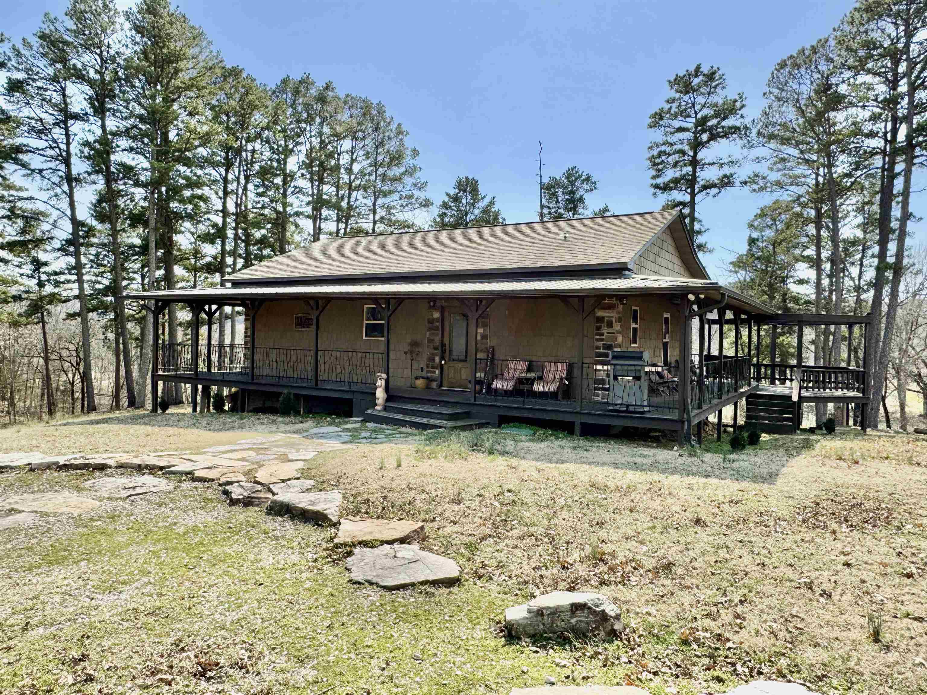FULLY FURNISHED CUSTOM HOME WITH A RIVER VIEW! This 2 bedroom, 2 bath home features an open living room/kitchen with vaulted ceilings. The living room has a gas log fireplace. The kitchen has granite countertops, custom cabinets, pantry, & wine cabinet. The Master suite has an attached full bathroom with walk in tile shower, and two closets. The home has a complete wrap around porch with an attached grilling deck! Located on a large lot about 1 mile from the AGFC boat launch and a short drive to area hiking trails!