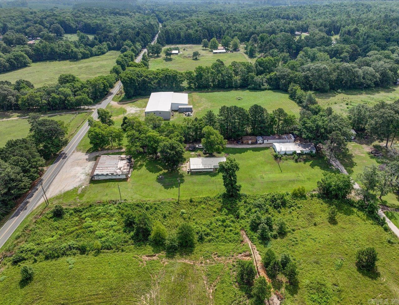 Charming old farmhouse with shops, storage buildings, and historic grocery store (3000 SF) on 2 acres.  Approximately 160ft of Amity Rd frontage.  Step back in time with this unique and versatile property on 2 acres of countryside charm.  This classic home offers the perfect canvas for restoration or creative reinvention.  Adjacent to the house (1440 sf), you will find two sizable shops (shop 1=1960 sf and shop 2= 1440 sf) ideal for wood working, automotive work, or small business operations.  Additional storage buildings offer ample storage for equipment and tools.  Adding even more potential, the property includes an old historic grocery store building that could be restored as a retail space, studio, or unique venue.  This property offers a rare opportunity for homesteading, small business ventures, or quiet country retreat.  Addresses are 3669, 3671, and 3673 Amity Rd.