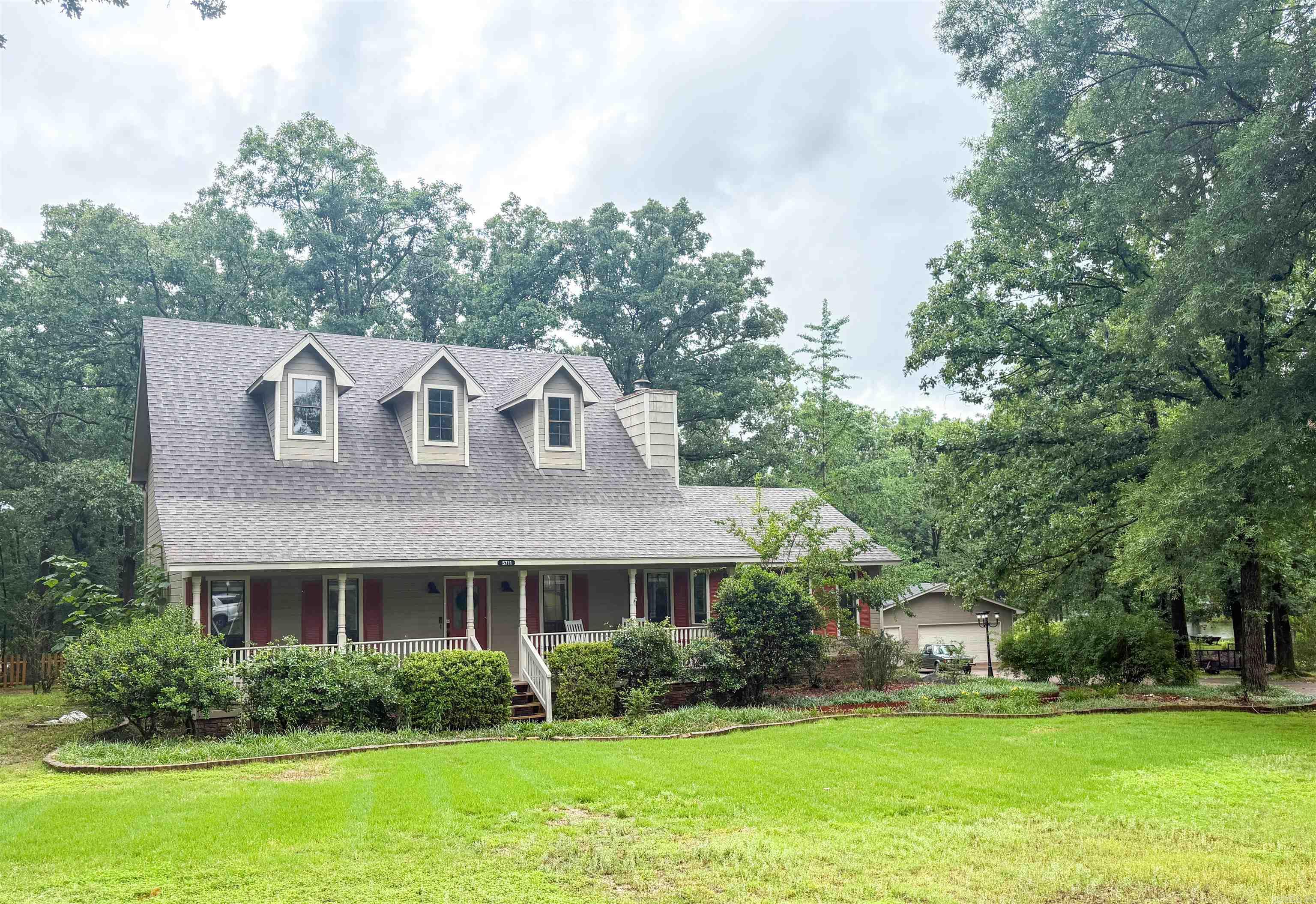 Welcome to 5711 Red Bud Lane — a beautifully maintained home nestled in one of Little Rock’s established neighborhoods. This inviting property offers the perfect blend of comfort, functionality, and curb appeal with spacious living areas, abundant natural light, and a layout designed for everyday living and entertaining alike.  Enjoy the warm and welcoming atmosphere featuring 3 generous bedrooms, 2 full and 1 half bath for guests, a well-appointed kitchen, and comfortable indoor/outdoor spaces ideal for relaxing or gathering with friends and family. The 1 acre lot provides room to garden, play, or simply unwind in a peaceful setting.  New flooring & paint (2024), newer roof (2022), tankless water heater, and the home was just professionally pressure washed so all the outside maintenance is done!  Check out the 24x30 shop that is in addition to the 2 car attached garage! Conveniently located near shopping, dining, parks, and top local amenities, this home combines neighborhood charm with easy access to everything Little Rock has to offer. Whether you are a first-time buyer, growing family, or looking to downsize without compromise, 5711 Red Bud Lane is ready to welcome you home.