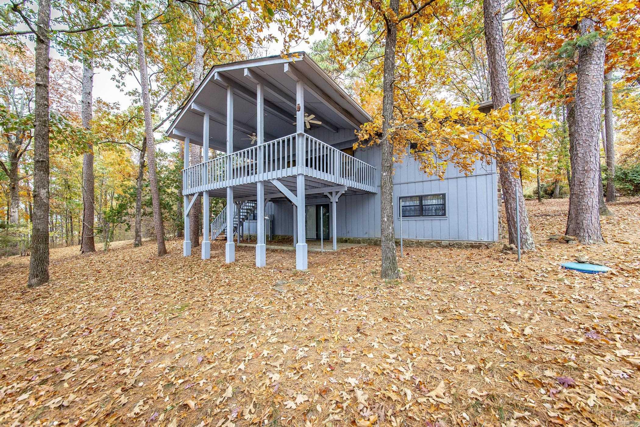 Lakefront Living in Mystic Isle on Greers Ferry Lake! Discover the perfect blend of comfort, recreation, and relaxation in this beautifully positioned 3-bedroom lakefront home. Whether you're searching for a full-time residence, weekend getaway, or vacation rental opportunity, this property is designed to make the most of lake life. The thoughtfully designed floor plan features two levels on the lakeside, with the lower level offering two guest bedrooms, a shared bath, and walkout access to the lake, providing privacy and convenience for family and friends. Step outside and enjoy an impressive 165 feet of shoreline frontage, complete with a sandy beach and one of the area's most desirable swimming spots. Spend your days fishing, swimming, kayaking, or simply soaking in the peaceful surroundings. Located at the mouth of Middle Fork, this property offers exceptional water access and a setting that lake enthusiasts dream about. From sunrise coffee on the deck to afternoons on the water, this is the kind of place where lifelong memories are made. Come find your happy place on Greers Ferry Lake!