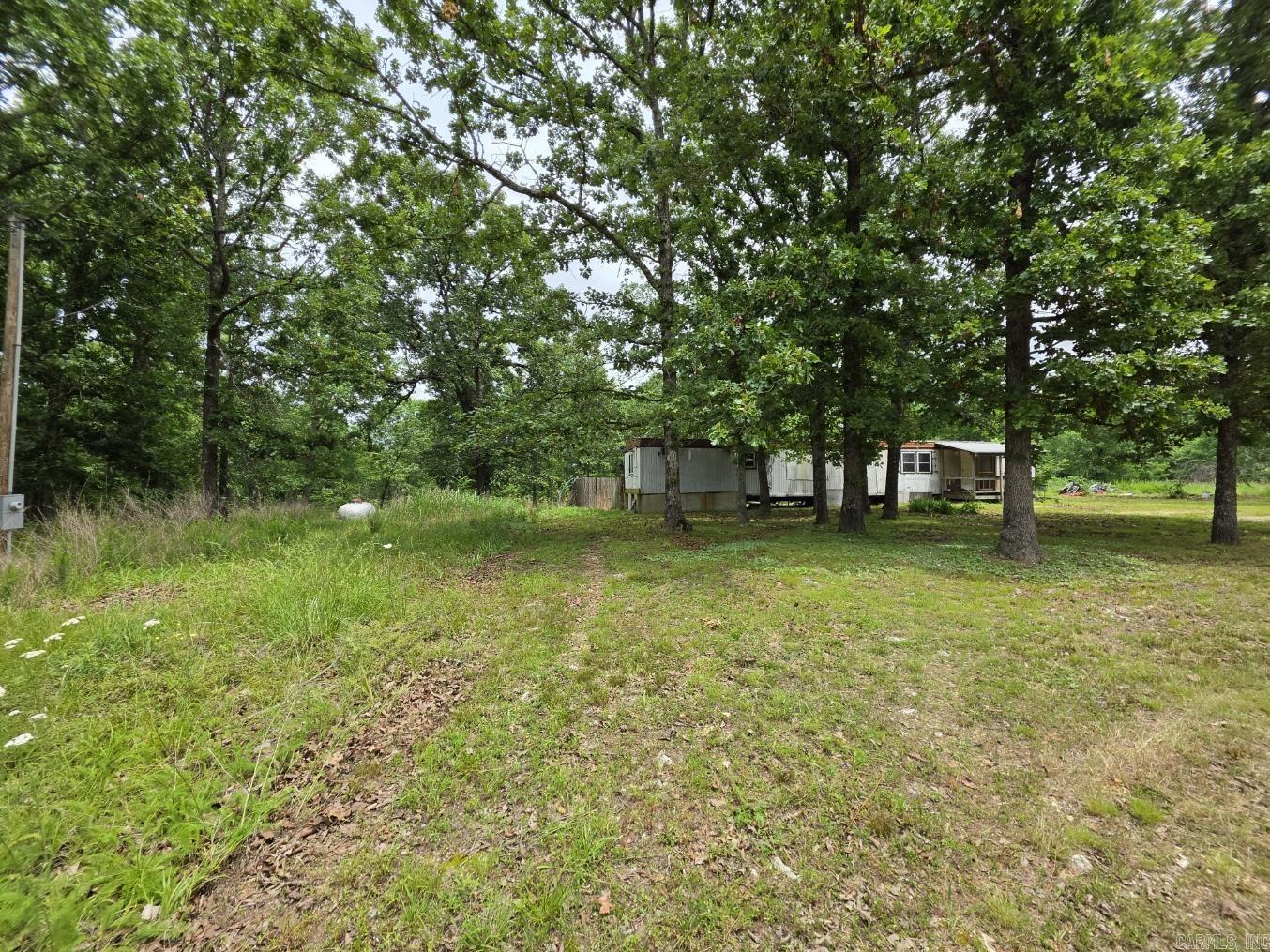 Unrestricted 5-Acre Retreat Near the Spring River! ?Escape to the Ozarks! Nestled just outside Mammoth Spring, this 5-acre property offers the perfect blend of mature shade trees, open space, and ultimate freedom. With no restrictions, the possibilities here are truly endless--whether you want to build your dream home, pull in an RV, start a hobby farm, or simply enjoy a private weekend getaway. Whether you're looking for a fixer-upper, the mobile home on the property will need significant repairs and updates to be made livable, but it provides a solid starting point or could serve as a great project or temporary structure or a beautiful piece of land to start fresh, this property is a rare find in a highly sought-after river area. Bring your tools, your vision, and your sense of adventure--properties with utilities and no restrictions don't last long!