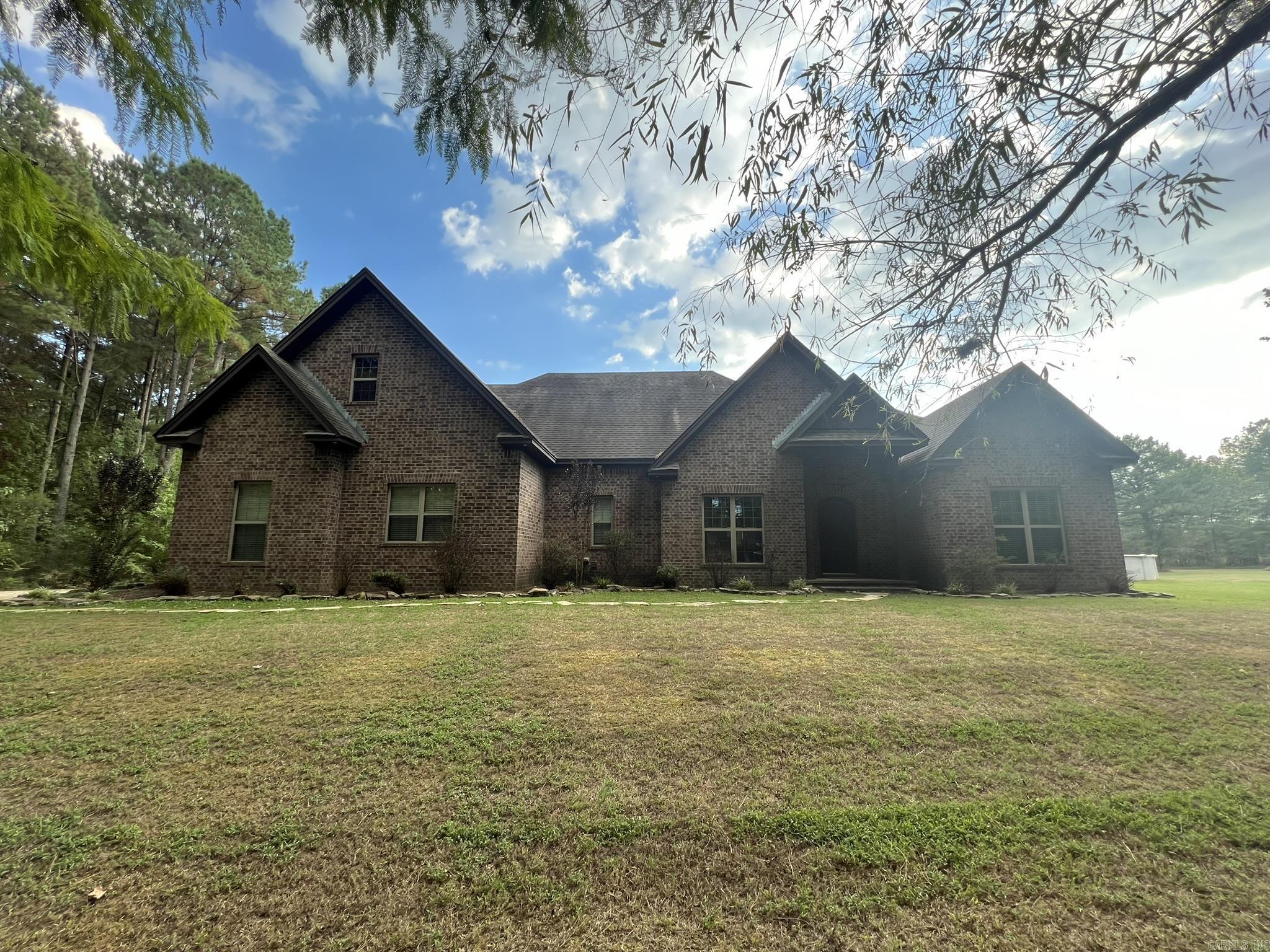 This is a very private, hidden away, & gorgeous custom home nestled in the middle of 10.04 acres on the west side of town only minutes from the city limits. This 4 bed, 4 bath house has 3416 Sq./Ft. M/L and a open floor plan with lot of custom upgrades. The home boasts: Stained concrete, Granite countertops, Custom cabinets, Double convection oven, 36 in smooth cook-top, Huge separate refrigerator & freezer, Huge walk in shower with seats & 2 shower heads, 6 ft Jacuzzi tub, Dual vanities with a make-up seating area in the master bath, 2 separate hot water heaters (one is a never ending tank-less just for the master), 9 foot ceilings with several extra trays, Custom crown molding, Safe room, Theater room, Game room & bar area, 2 car oversized garage, Pool with beautiful deck, Covered hot tub, 12x24 shed, & a Fully stocked pond with partially covered fishing dock. The 10.04 acres of land that comes with this home is very private & full of wildlife. If having a private oasis nestled in the woods only minutes from town that you can hunt and fish from is up your alley, then this one is a must see. Agents, see agent remarks.