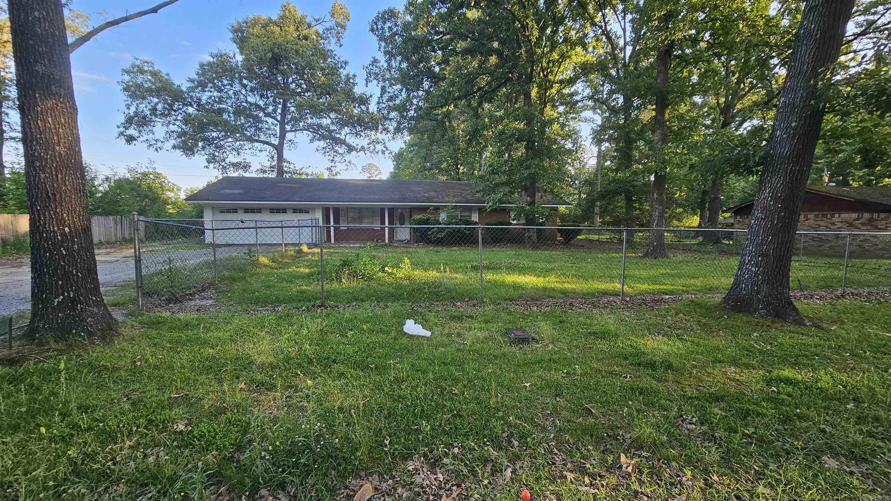 This 3 bedrooms/2 bathrooms brick home offering 1,680 sq. ft. on a spacious 0.34 acre lot with a functional layout and excellent opportunity to add your personal touch. The kitchen features abundant cabinet storage, black appliances, wall oven, and generous prep space, while the spacious living area provides plenty of room for relaxing or entertaining. Interior highlights include updated flooring, modern paint tones, wood ceiling accents, recessed lighting, ceiling fans, built-in shelving, and generously sized bedrooms and bathrooms. With solid space and character throughout, this property offers great potential for customization and future improvements.   Attached garage provides added convenience and storage, complemented by an updated garage door for improved curb appeal. Exterior features include a covered front porch, mature shade trees, fenced backyard, and a detached workshop/storage building ideal for hobbies, equipment, or extra storage. The backyard backs to open green space, creating a private and peaceful outdoor setting with plenty of room to enjoy. A great opportunity for buyers looking for a home with space, charm, and the chance to make it their own.