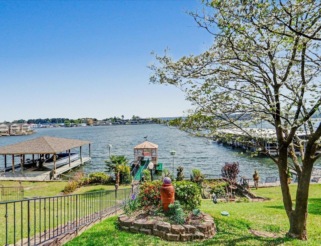 MOTIVATED SELLER! Lake Hamilton waterfront home on the main channel that qualifies for a Short-Term Rental license and has Entergy approval for a single-stall boat dock. Whether you're looking for a full-time residence, weekend getaway, or investment property, this home offers exceptional flexibility. Offered for the first time in over 50 years and back on the market through no fault of the seller.  The main level features an open floor plan with 2 bedrooms, 2 baths, including a primary suite with a walk-in closet. The sunroom opens to a covered lakeside deck with panoramic lake views, beautiful sunrises and sunsets, and a front-row seat to the annual Lake Hamilton fireworks.  The walk-out lower level offers a private entrance, 2 additional bedrooms, a full bath, second living area, bonus room, laundry room, and direct access to the lakeside patio. Located on a quiet, no-through street just minutes from Oaklawn, downtown Hot Springs, shopping, dining, and medical facilities. Schedule your private showing today!