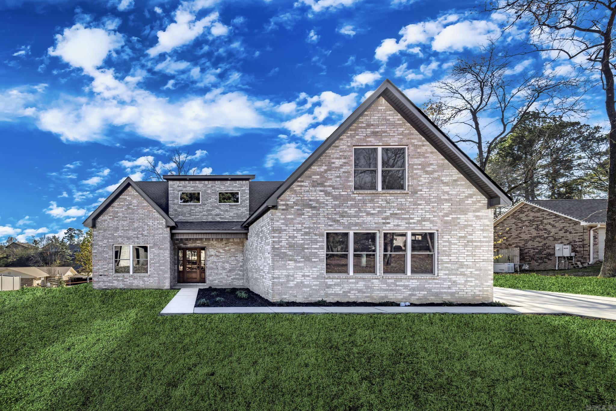 Welcome to your dream home at 168 Pico Circle in Hot Springs, Arkansas. This stunning new construction features four spacious bedrooms and three full baths, accompanied by a versatile bonus den and dedicated office space, perfect for modern living. The open-concept design seamlessly connects the living area and kitchen, creating an inviting space ideal for entertaining and family gatherings.Step into the kitchen, where contemporary finishes and generous counter space make meal preparation a delight. The kitchen flows effortlessly into the living area, which boasts a striking wood-beamed ceiling and large windows that fill the space with natural light. A cozy fireplace adds warmth and character, making it perfect for relaxation.The primary bath is a true sanctuary, featuring a freestanding soaking tub, dual vanities, and a beautifully tiled walk-in shower designed for comfort and elegance. You'll appreciate the sleek design and thoughtful storage solutions.Located in a desirable subdivision with lake access, this home offers a tranquil living environment and opportunities for outdoor activities.Embrace the serene surroundings and community amenities that make this area truly special