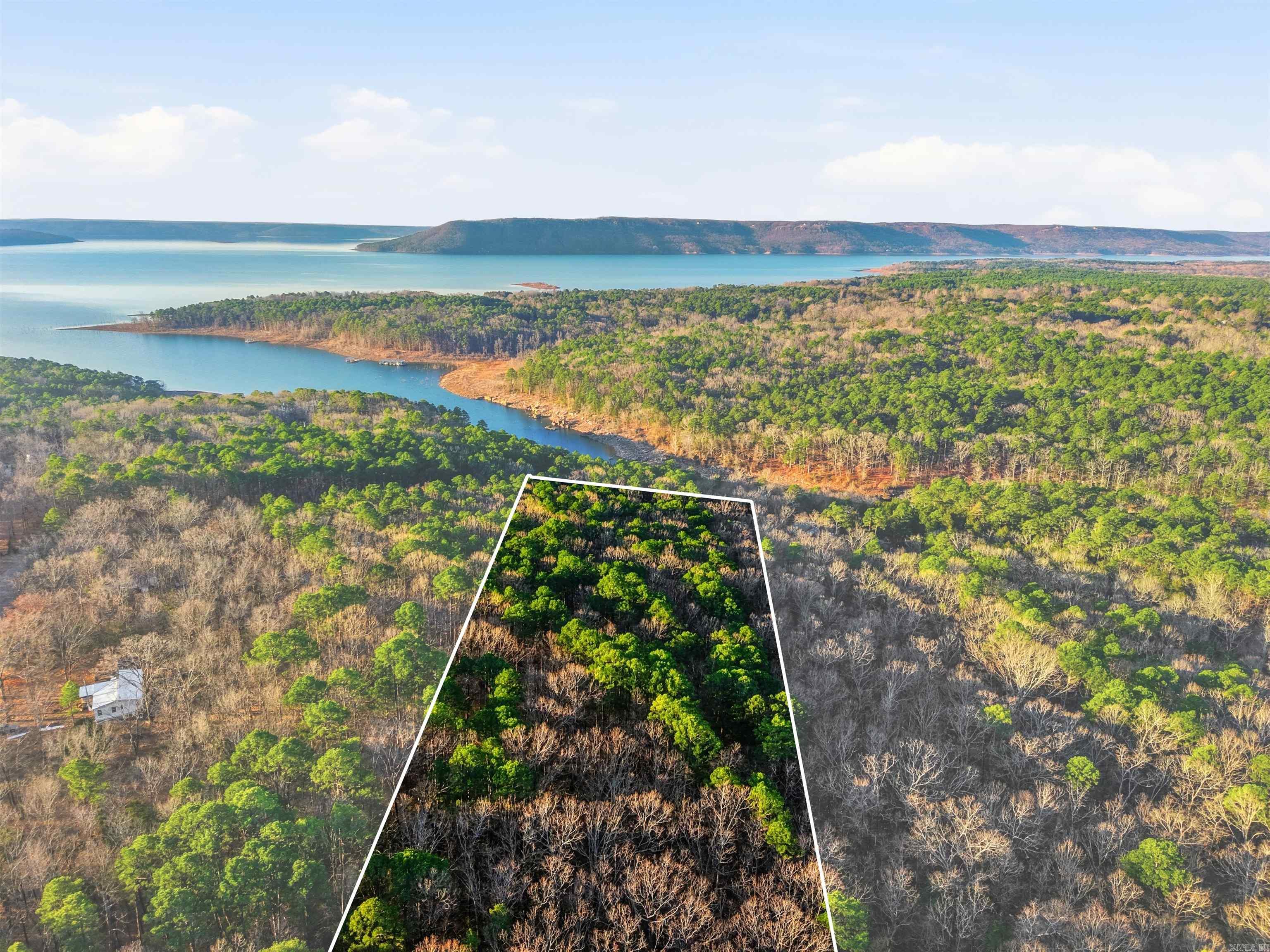 This beautiful waterfront property offers approximately 166 feet of water frontage at the mouth of Bud Creek and Greers Ferry Lake. This beautiful property features peaceful water views and a natural setting that’s perfect for relaxing or exploring the outdoors. With unlimited potential, this tract is ideal for recreation, a private getaway, or future development. Whether you’re dreaming of a weekend retreat, a lakefront homesite, or a possible Airbnb investment, this property offers the space, scenery, and location to make it happen. It is a 10 minute drive or roughly 3 miles by water to Shiloh Marina.