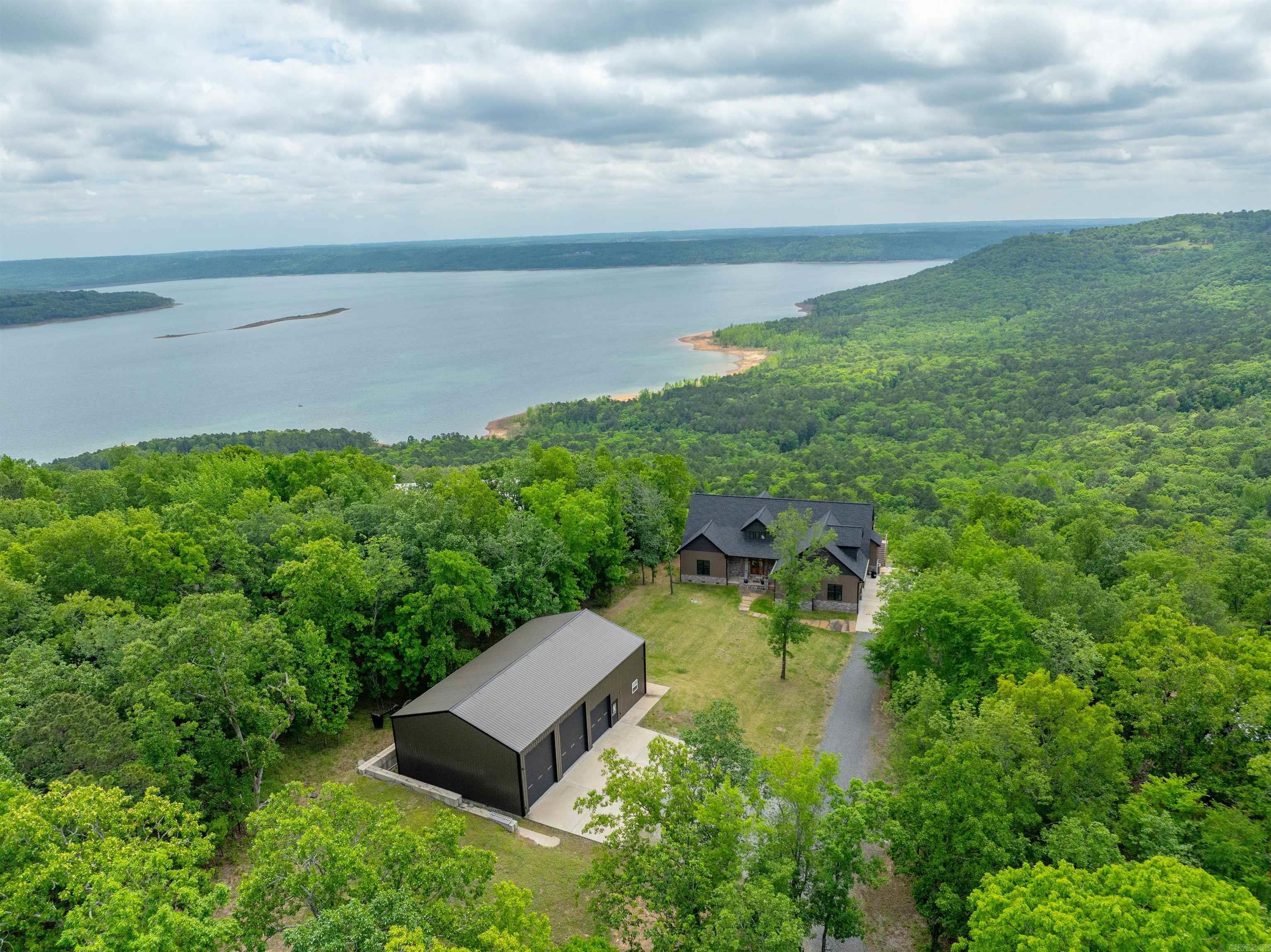Diamond Bluff LAKE VIEW HOME!!!  This amazing home, built in 2023, has it all!  Perfect for a vacation home or full-time living!  HOME ----- 4 bedrooms and 3 full baths, and some of the best views that I've seen in my almost 30 years of selling Cleburne County...the views are simply unbelievable!  Main level = 3 bedrooms, 2 full baths, office (which could be 4th bedroom), kitchen, living, dining and laundry.  Kitchen has quartz tops and stainless appliances, large island, breakfast bar and an amazing panty!  Living area with vaulted ceilings and fireplace.  2-car garage and plenty of parking.  Upstairs is very large room that can be additional living space or a 5th bedroom and a full bath upstairs!  Main level hall bath and guest bedrooms are all wheelchair accessible.  1,500 square foot deck that is partially covered and includes an outdoor fireplace, plus a beautiful rock patio for entertaining!  This home is piered to bedrock and is spotless inside and out!  SHOP ----- 60' x 36' shop includes a 16' x 36' apartment with full bath!  Shop has concrete floors, 3 overhead doors and is just as nice and tidy as the home!