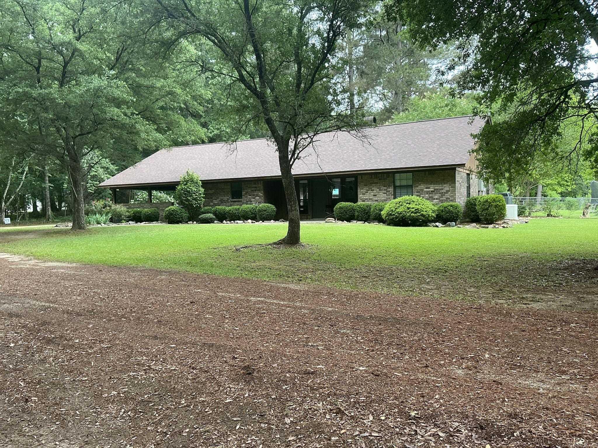 This Beautiful move-in-ready country home is sitting on 10.90 acres (lot 22 & 23) with a pond, 5 stall barn  a large shed, located in Frost Prairie with a beautiful front porch to welcome everyone. Home  features  nice open floor plan with kitchen/dining/living room combo. Kitchen has updated tile backsplash and granite tile counter tops. Beautiful view of the front yard from the kitchen sink. Living room is large with a wood-burning fireplace and built ins, 3 bedrooms, 2 baths.  Master bedroom is large, has great walk-in closet, door exiting to the wonderful covered patio, master bath with shower over bathtub. Other two bedrooms are located on opposite side of living room with the hall bathroom featuring shower over the bathtub. Architectural roof installed 10/2025, central unit, tile floors, luxury vinyl flooring. The home has a new generator installed for backup power. Will not come on automatic but can be turned on and is sold as is.The backyard is fenced and pastures  property is mostly fenced. This is a great move in ready country home!  Seller ask no one walk the land without notice.  Seller will have to put horses in the barn and need 24 hrs notice.