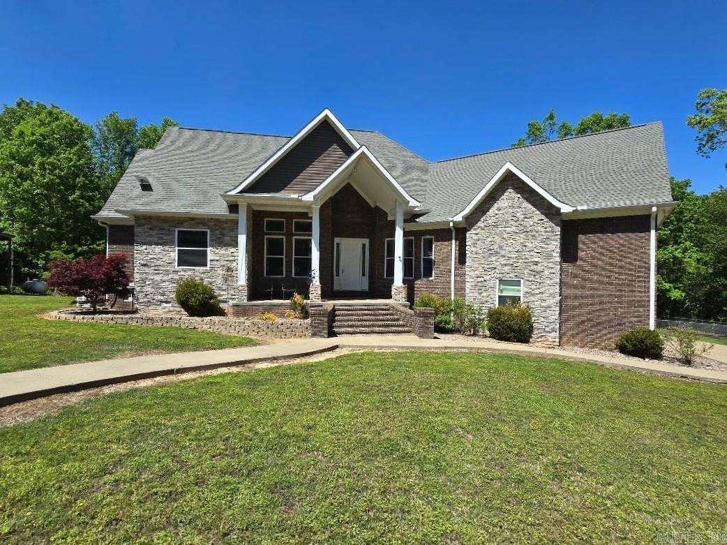 Peace and privacy await! With almost 39 acres, this 3 BR/3BA retreat offers privacy and comfort. First impression, a concrete drive leads to both the home and 40x40 shop. The inviting front porch and huge patio are ideal for outdoor entertaining. The main level offers a spacious great room that includes the living room and a kitchen featuring black shaker-style cabinetry with pull-out storage and granite countertops. A beautiful double-sided fireplace wall offers warmth and visual appeal while connecting the living room and formal dining. The primary suite offers solitude with a generous bedroom, dual vanities, walk-in closet, tub, and a spa-inspired shower complete with a built-in bench and rainfall showerhead. Also on the main level are two more bedrooms, a full bath, and office. Upstairs is a bonus room, a full bath, and walk-in attic access. Outdoors, enjoy a beautifully maintained lawn and pond. A storm shelter & backup generator ensures peace of mind year-round. A pad is ready and there are extra bricks included for a future outdoor kitchen should buyer choose.